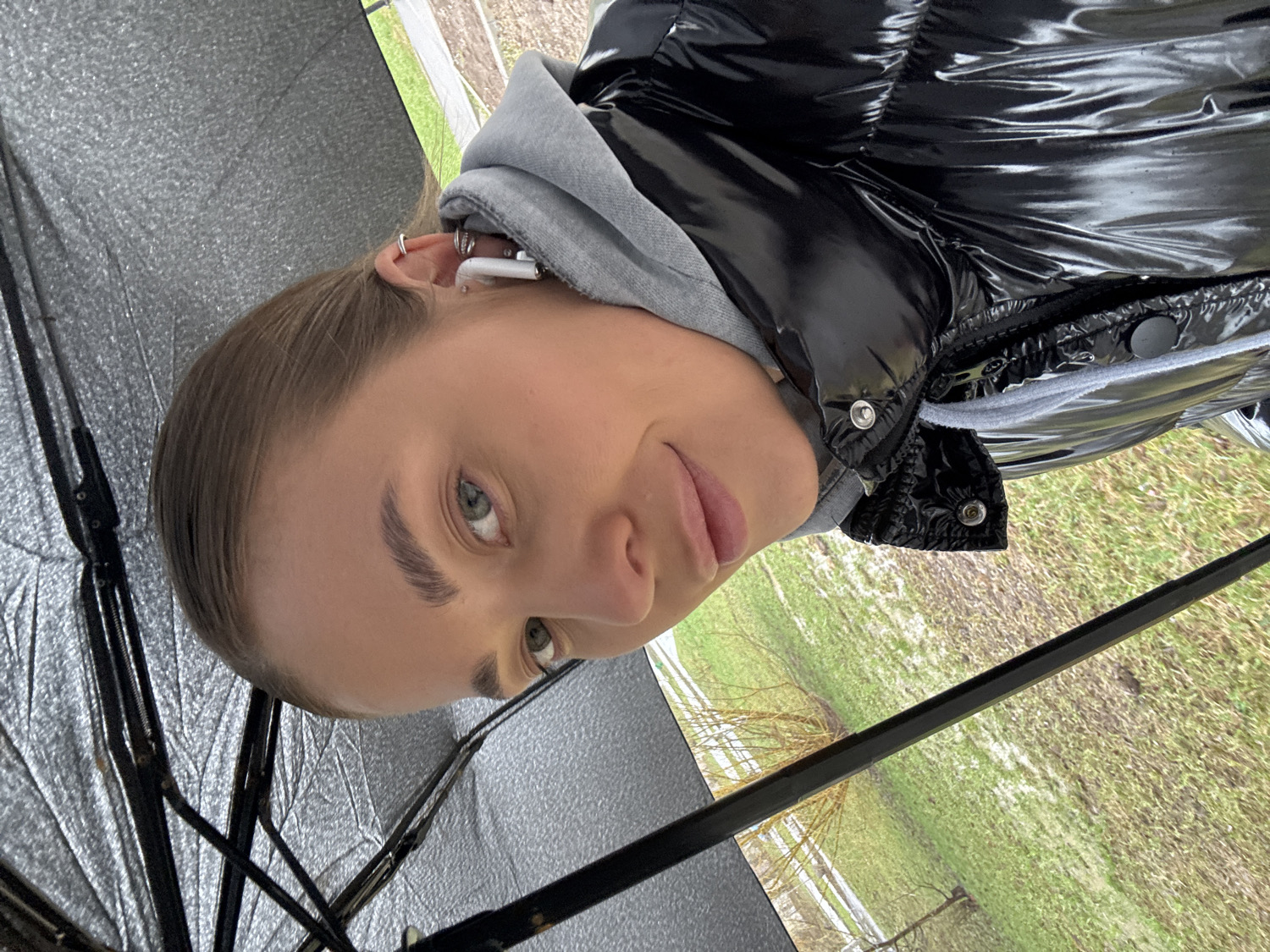 Woman takes umbrella selfies during outdoor walk in Chernushka