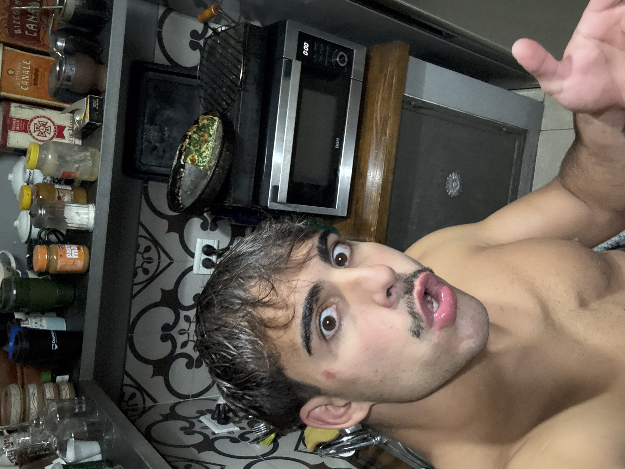 Late night kitchen selfie and quiche remnants documented in Argentina