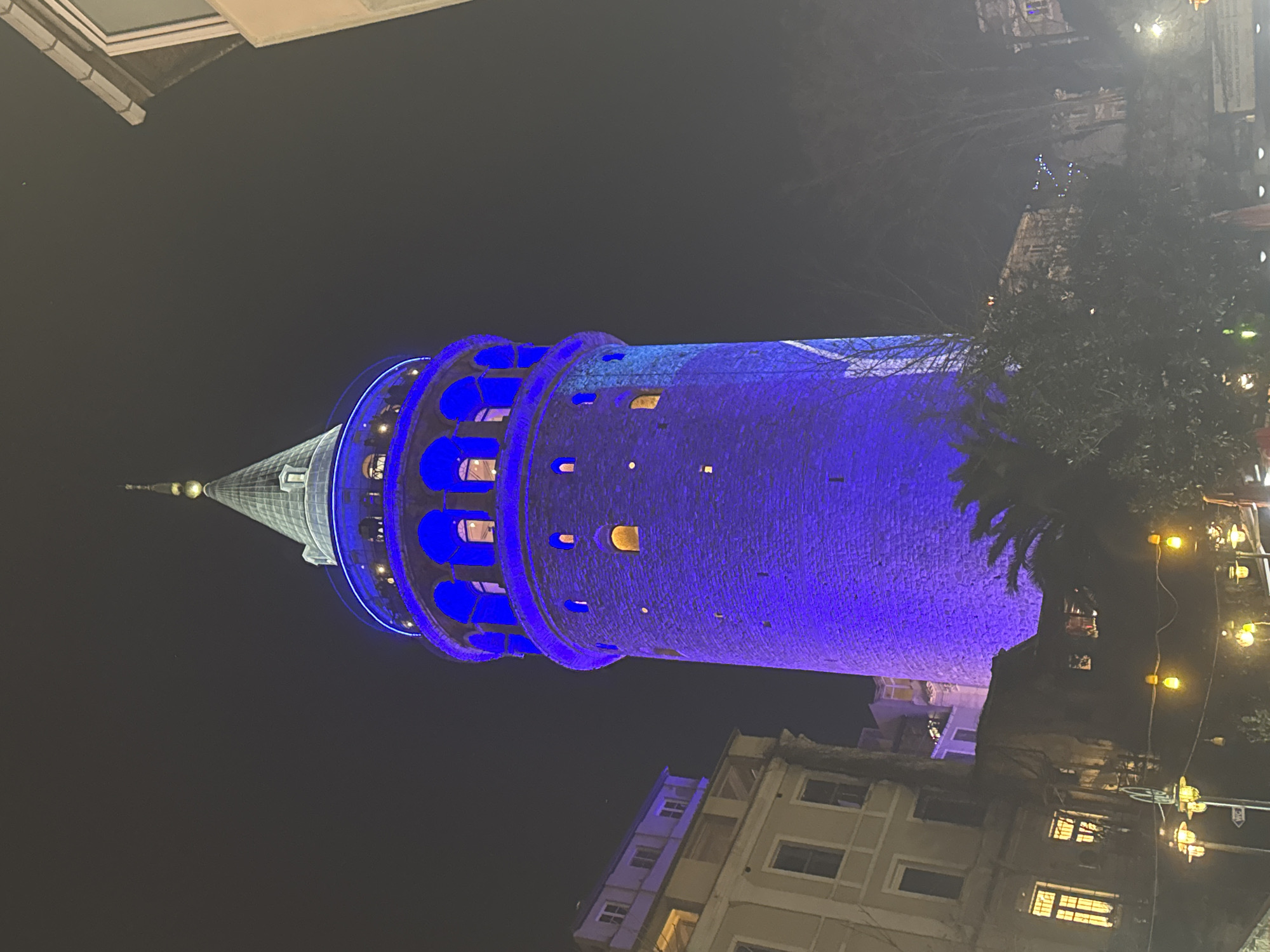 Galata Tower glows blue in Istanbul evening illumination