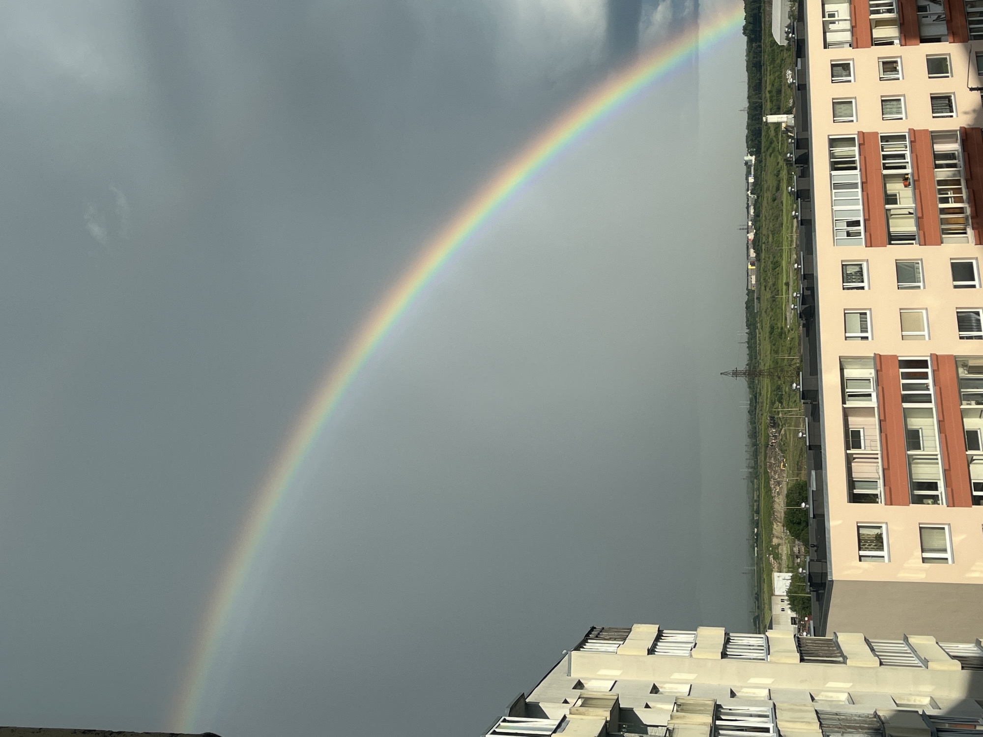 Bright rainbow over Tallinn's skyline on a grey afternoon