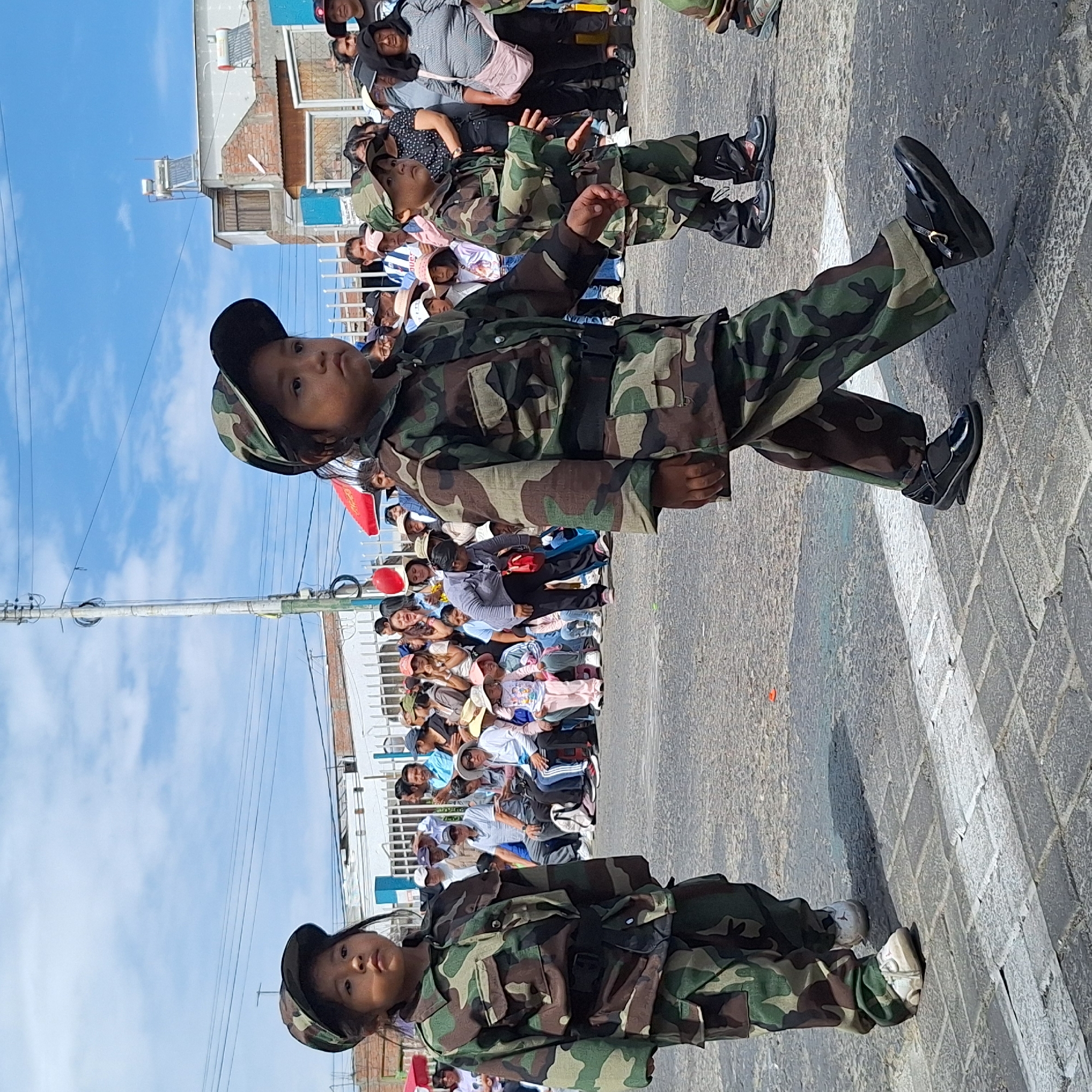 Children in camouflage uniforms march in Paucarpata parade