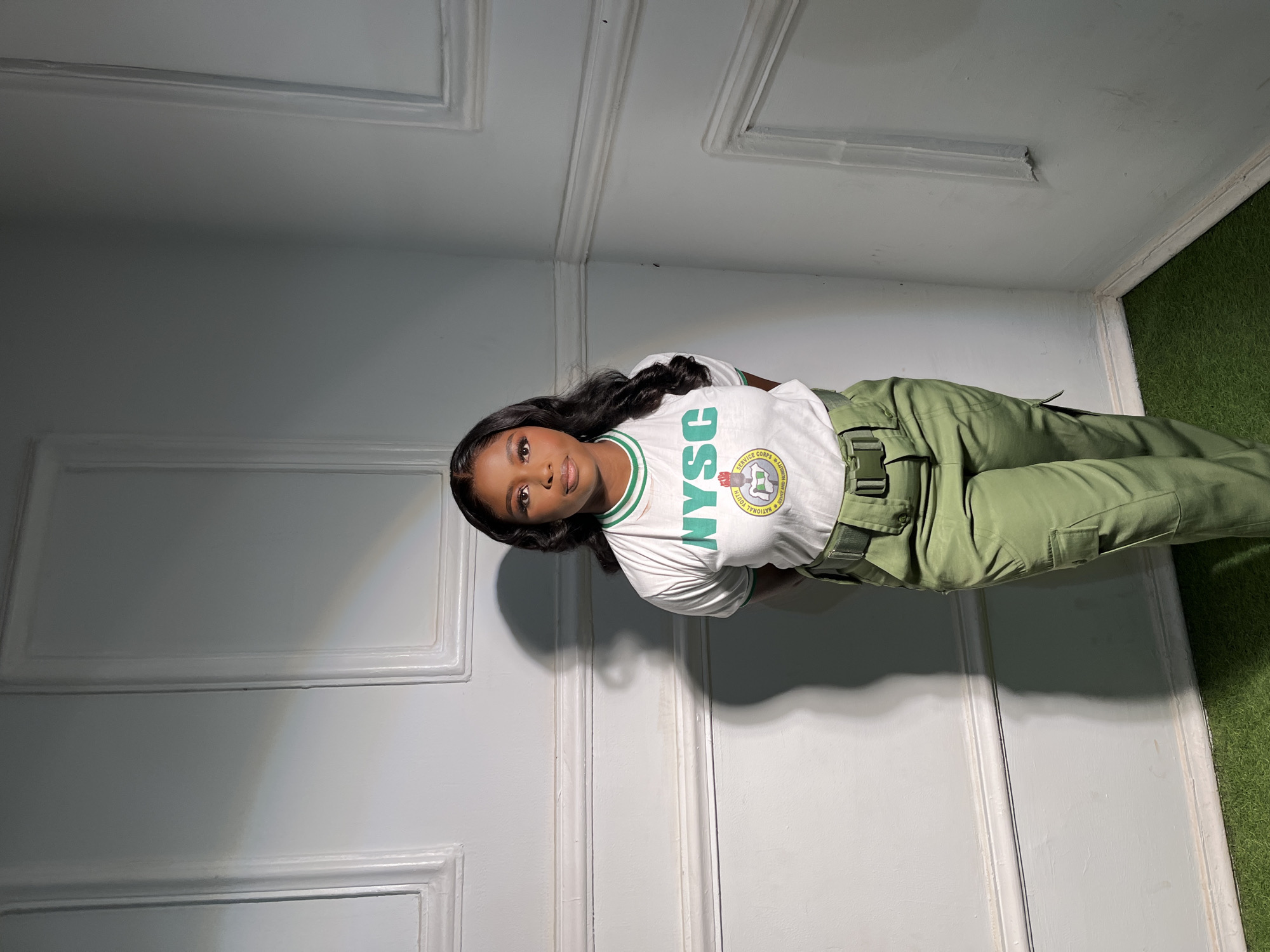 Woman poses in NYSC uniform during service year in Jos