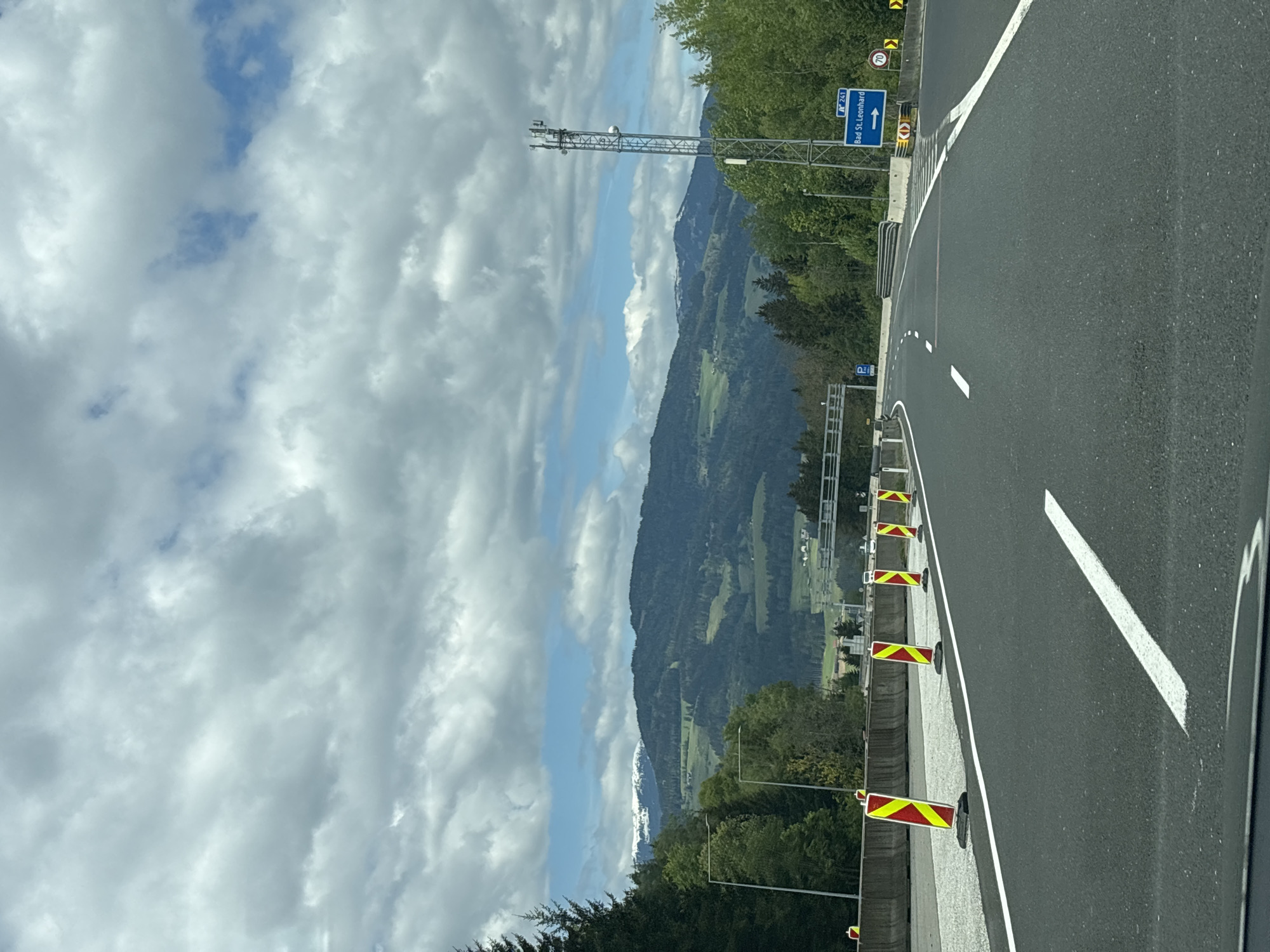 Vehicle travels curved highway section near Bad Sankt Leonhard, Austria