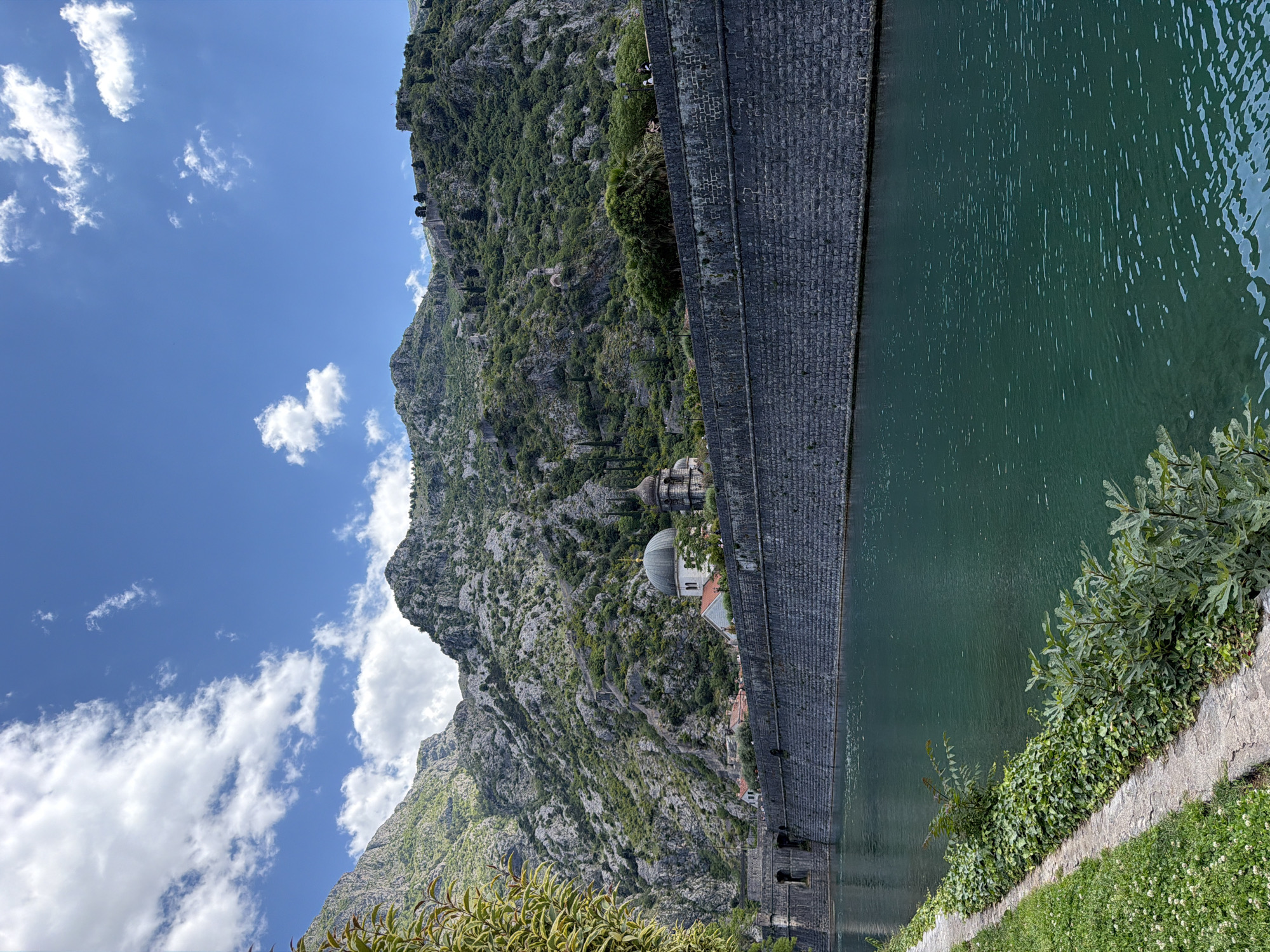 Tourist documents morning scenes in historic Kotor, Montenegro