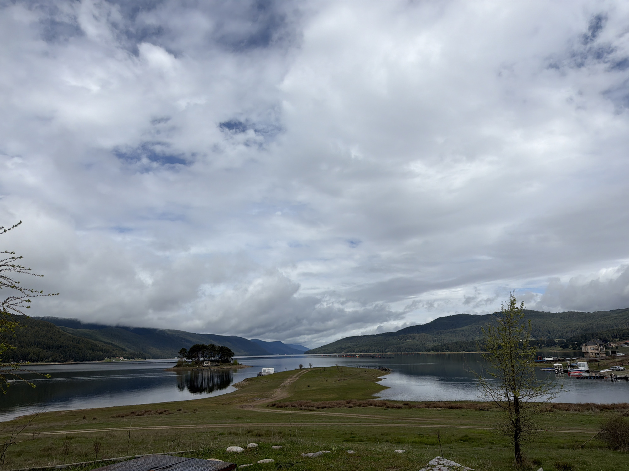 Morning clouds reflect across Lake Dospat, Bulgaria