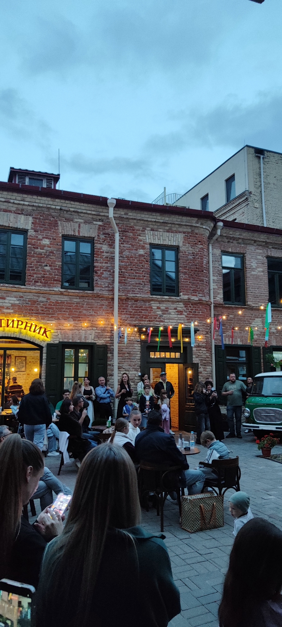 Live acoustic set in a Hrodna courtyard venue, evening.