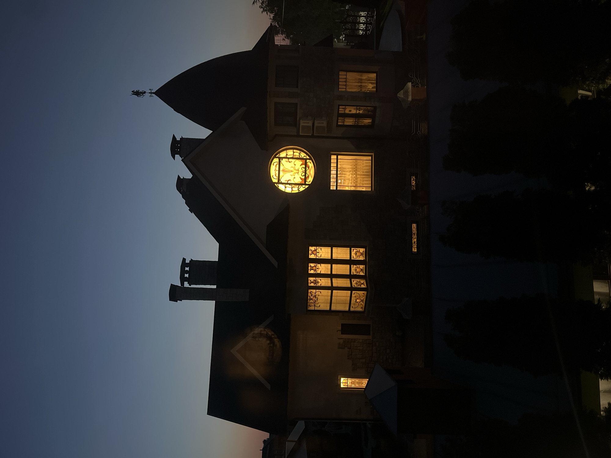 Twilight view of a Balakovo house with glowing stained-glass window