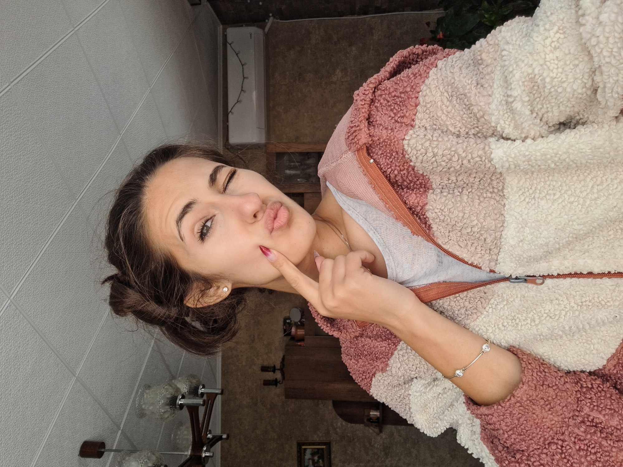 Woman poses playfully for photos in Bulgarian home Friday morning