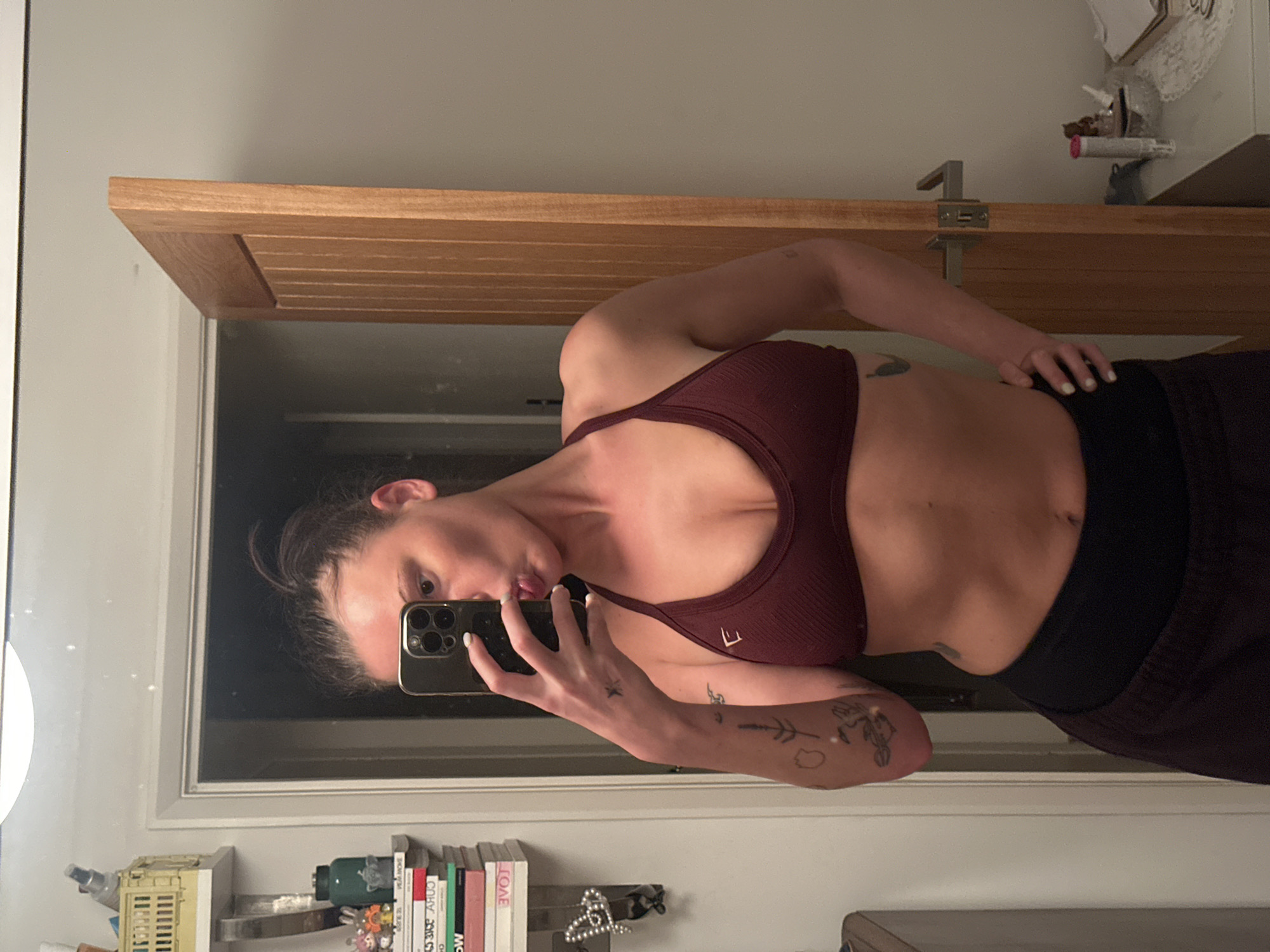 Woman takes bathroom selfie in workout attire