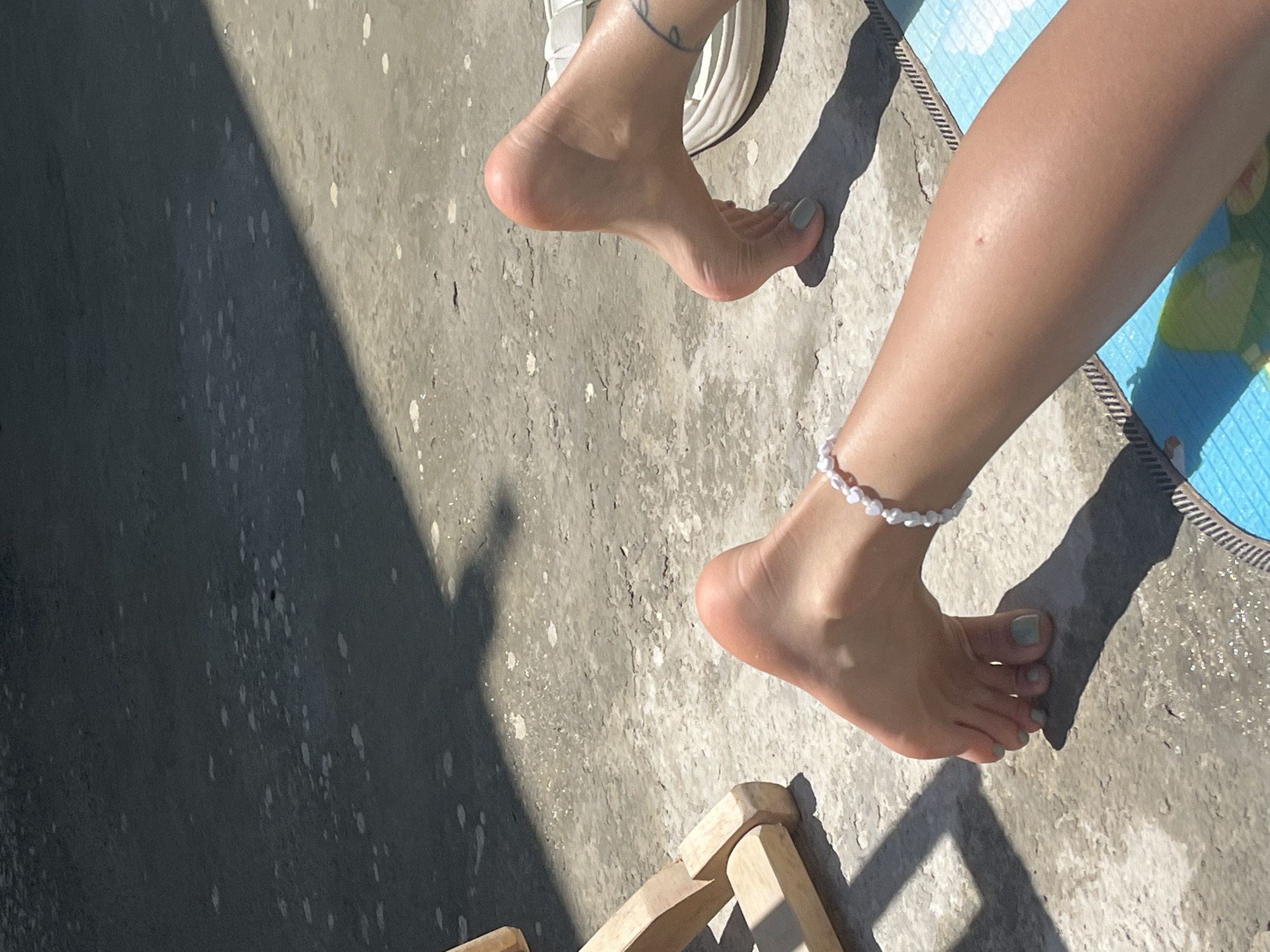 Sunny backyard morning: towels, deck chairs, and bare feet