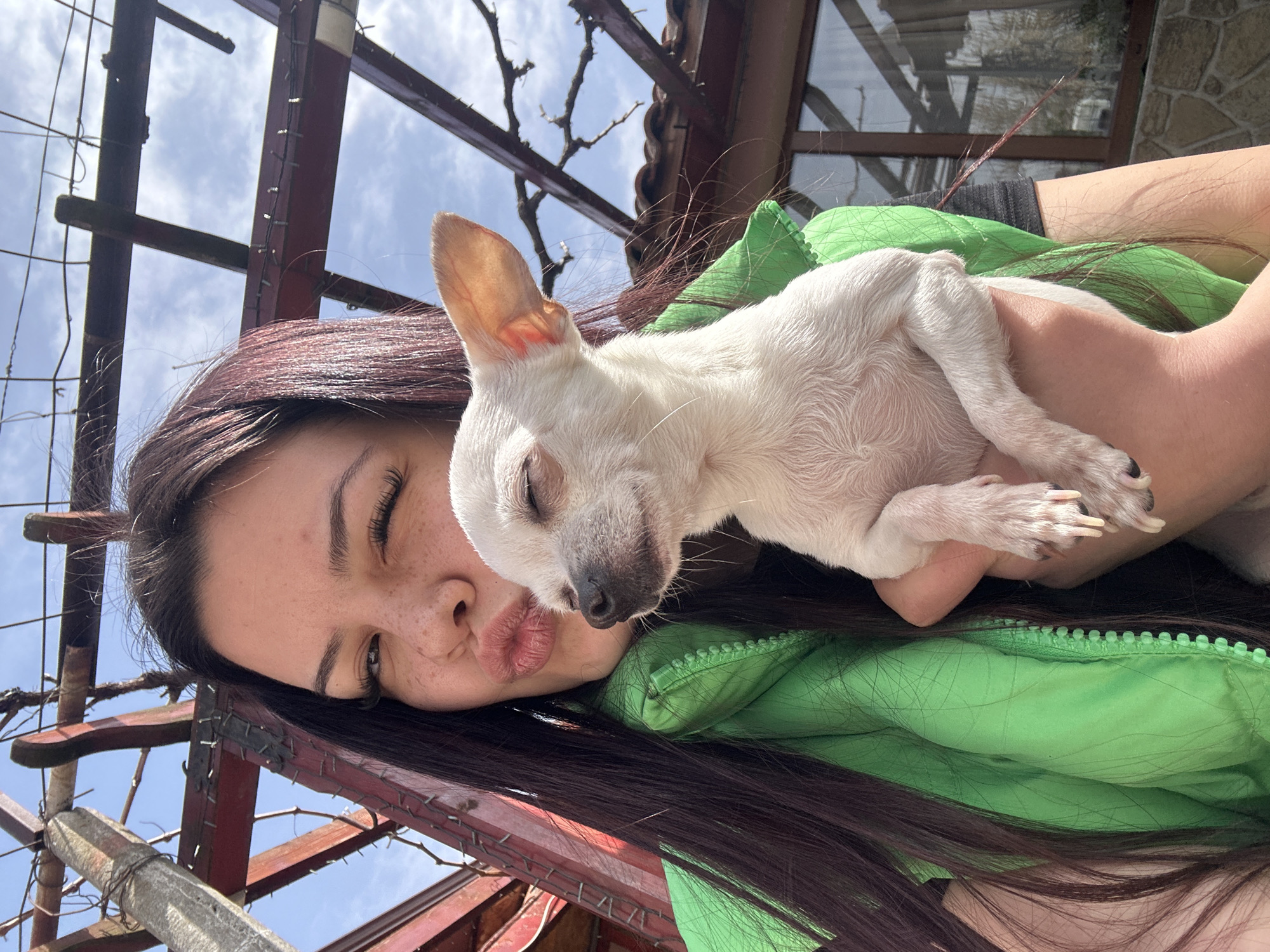 Woman enjoys morning coffee with white dog in Bulgaria