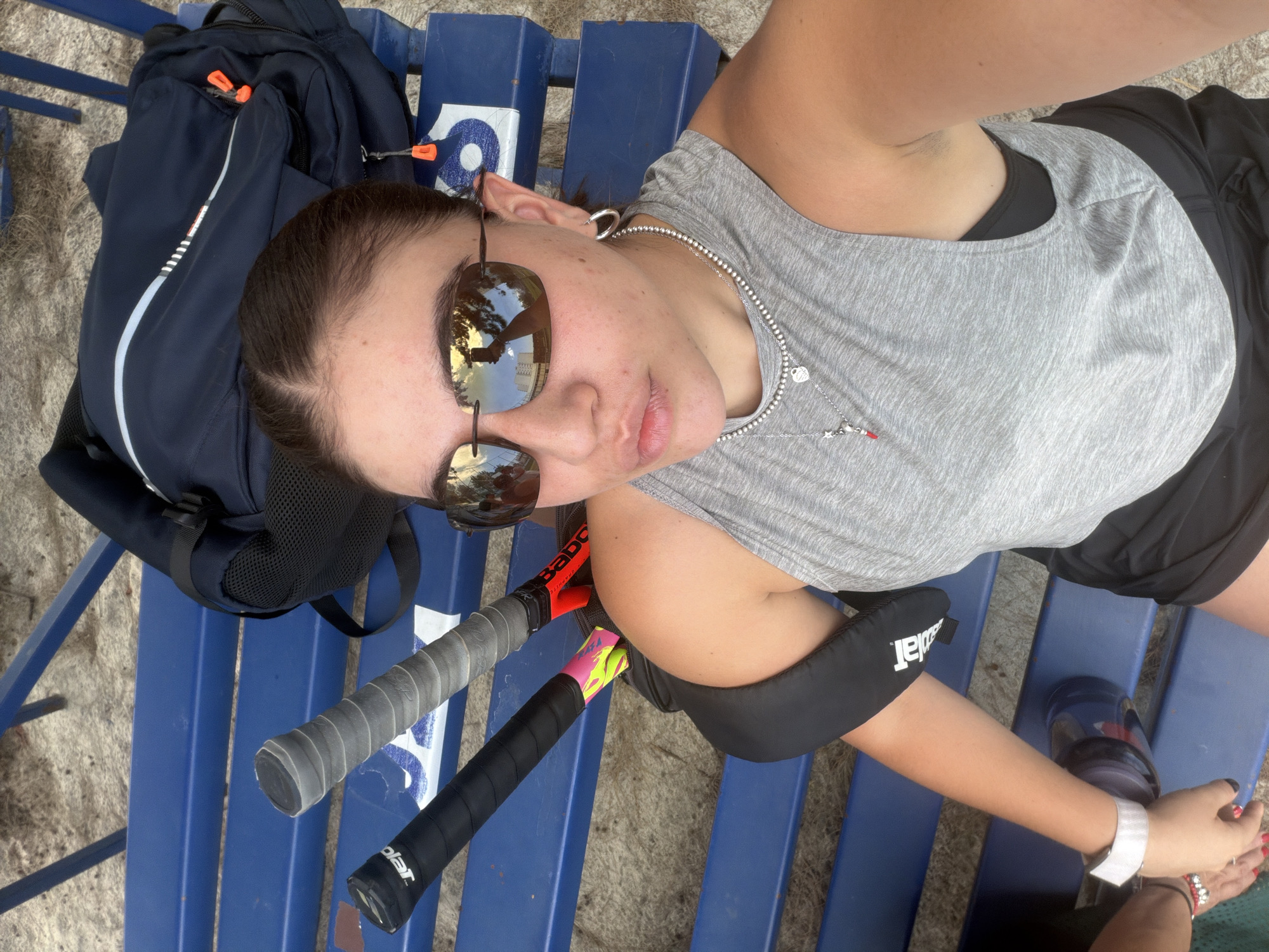 Tennis player rests on park bench in Puebla
