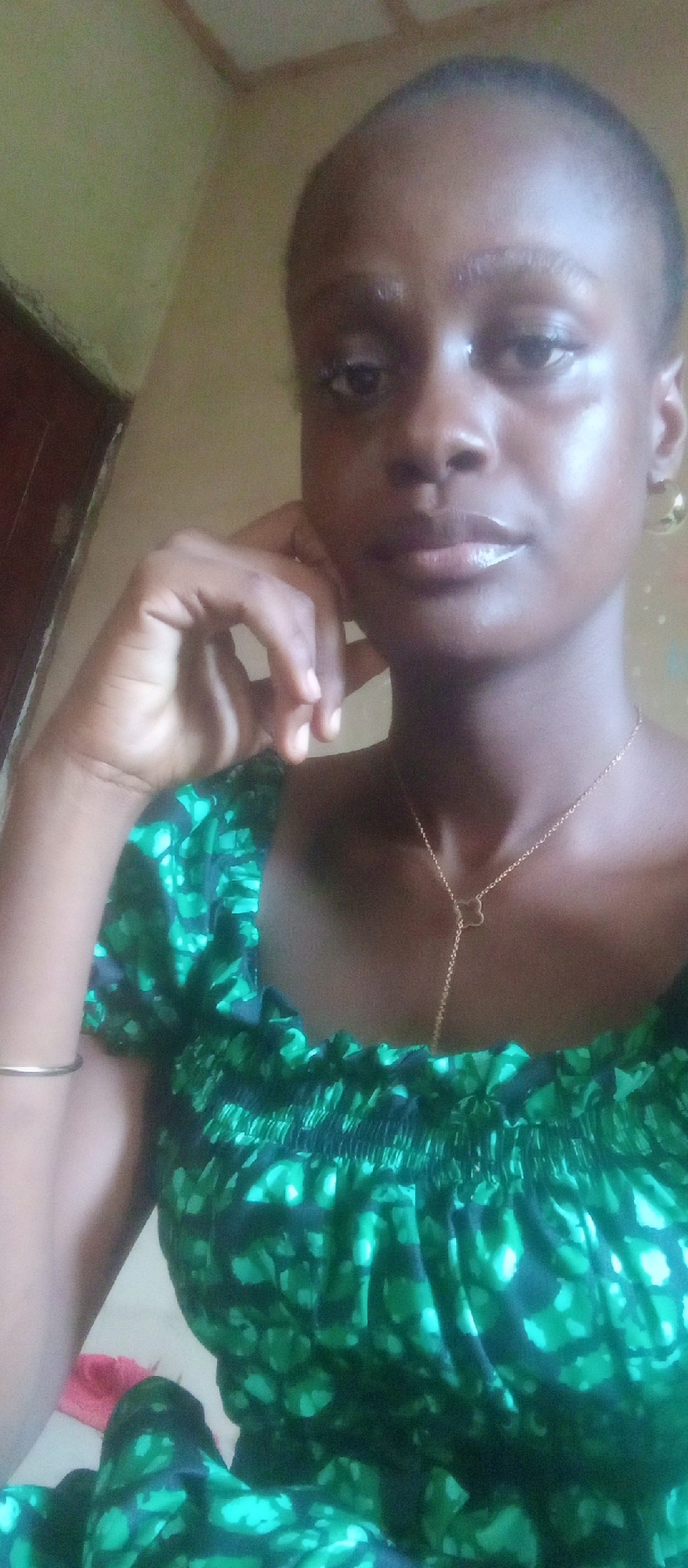 Woman photographed in green patterned outfit in Akwanga, Nigeria