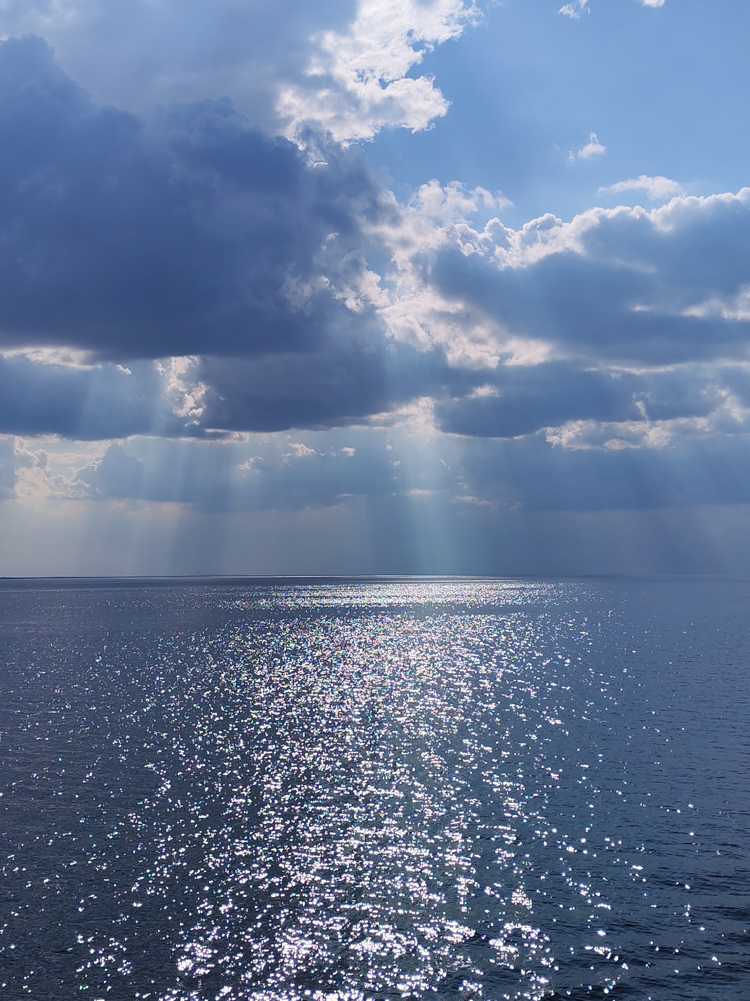 Dramatic sunbeams pierce storm clouds over Belozersk waters