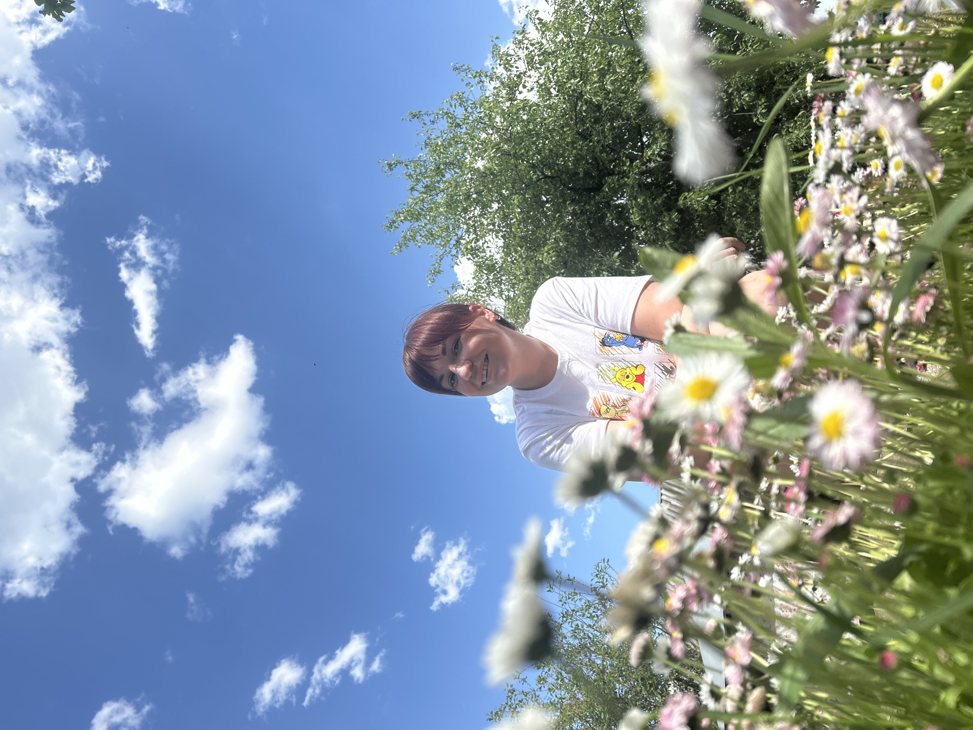 Woman poses in blooming daisy field in Russia