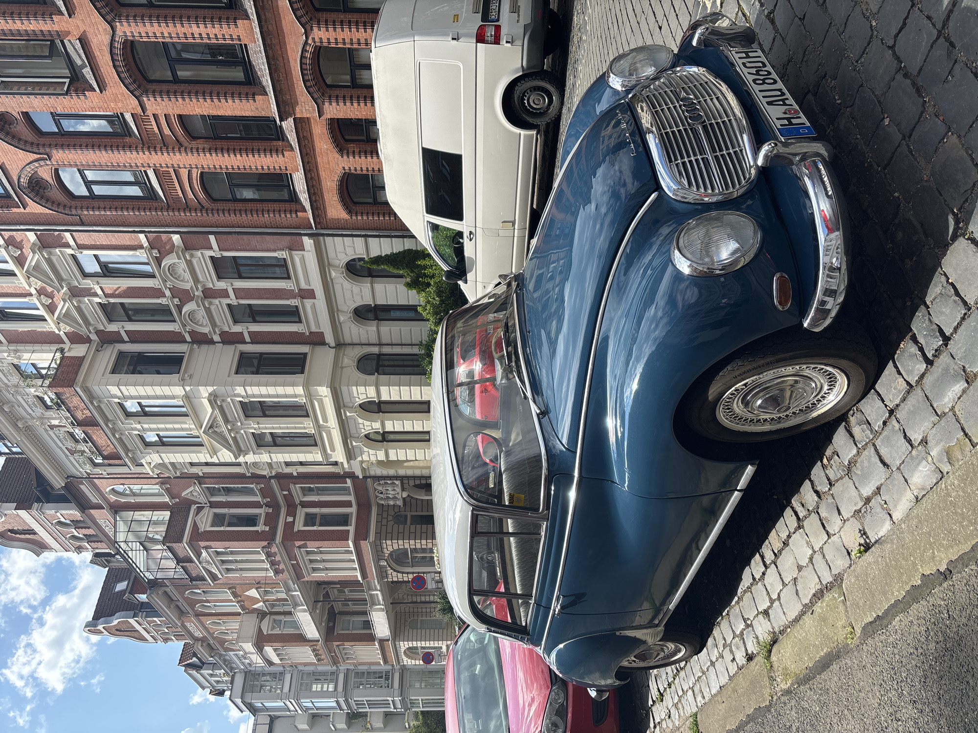 Vintage teal car parked on Hanover cobblestones
