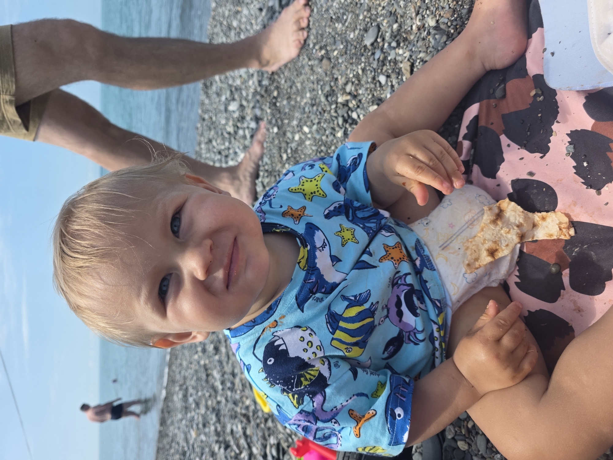 Toddler enjoys beach morning with flatbread in Sochi