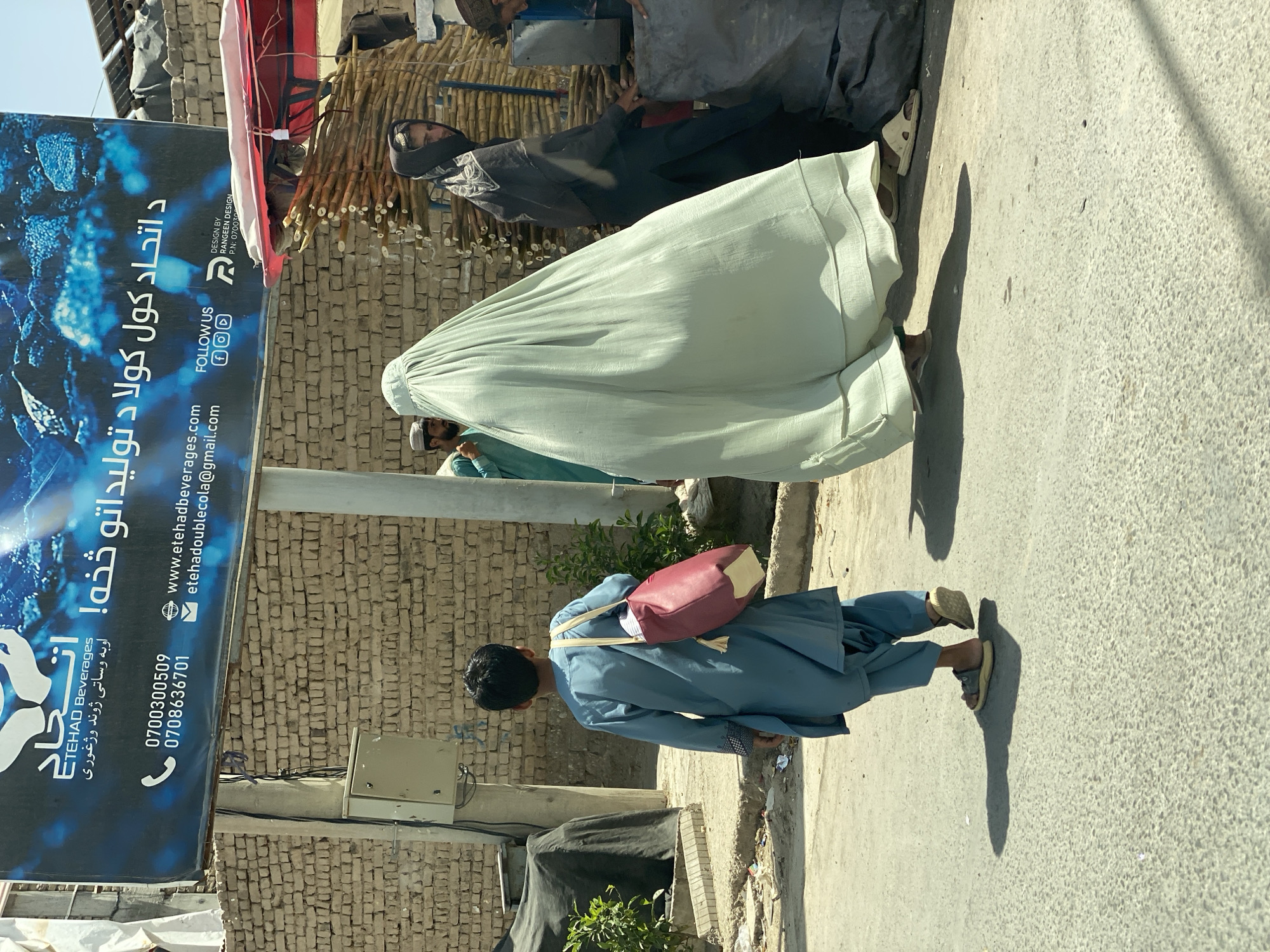 Everyday street life across a commercial district in Kandahar