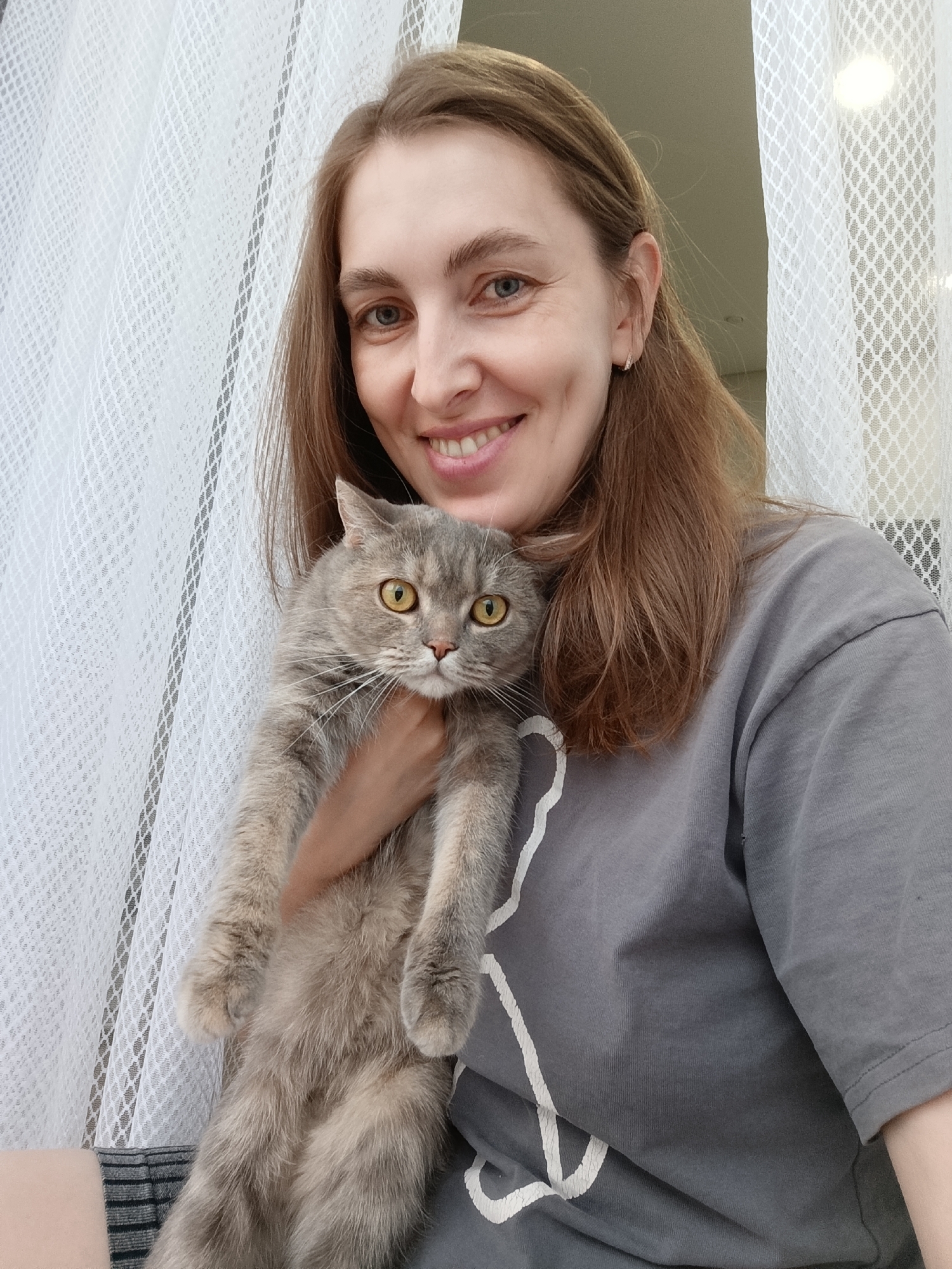 Woman photographed with cat and art project in Chaikovsky