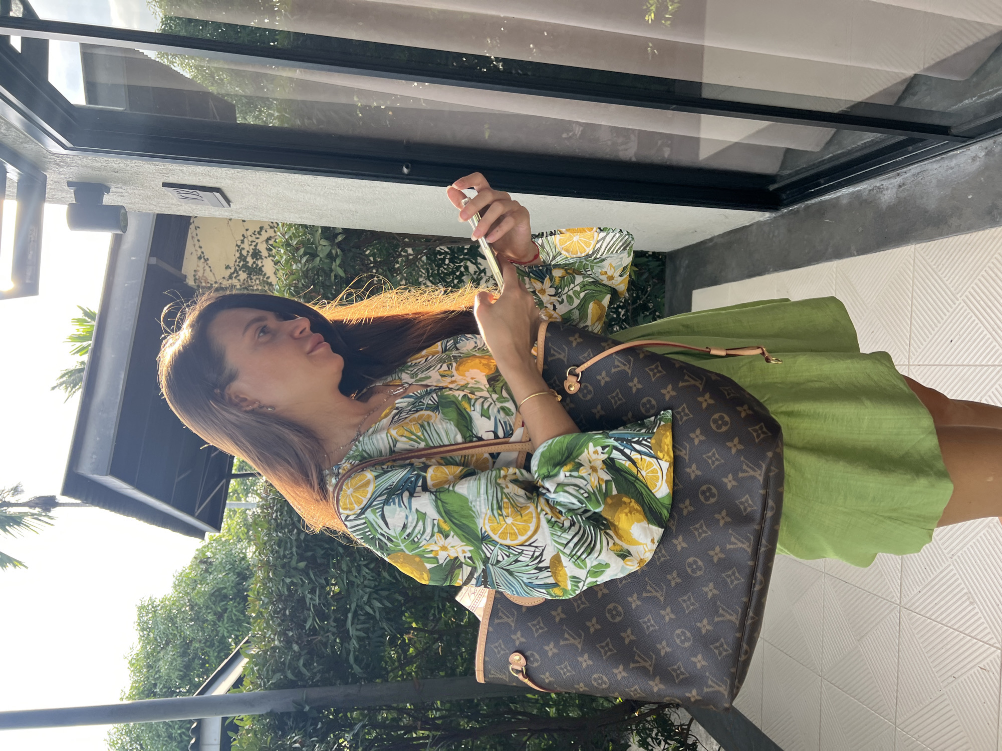 Woman with phone, walking observed in บ้านบางรักษ์; couple films selfie