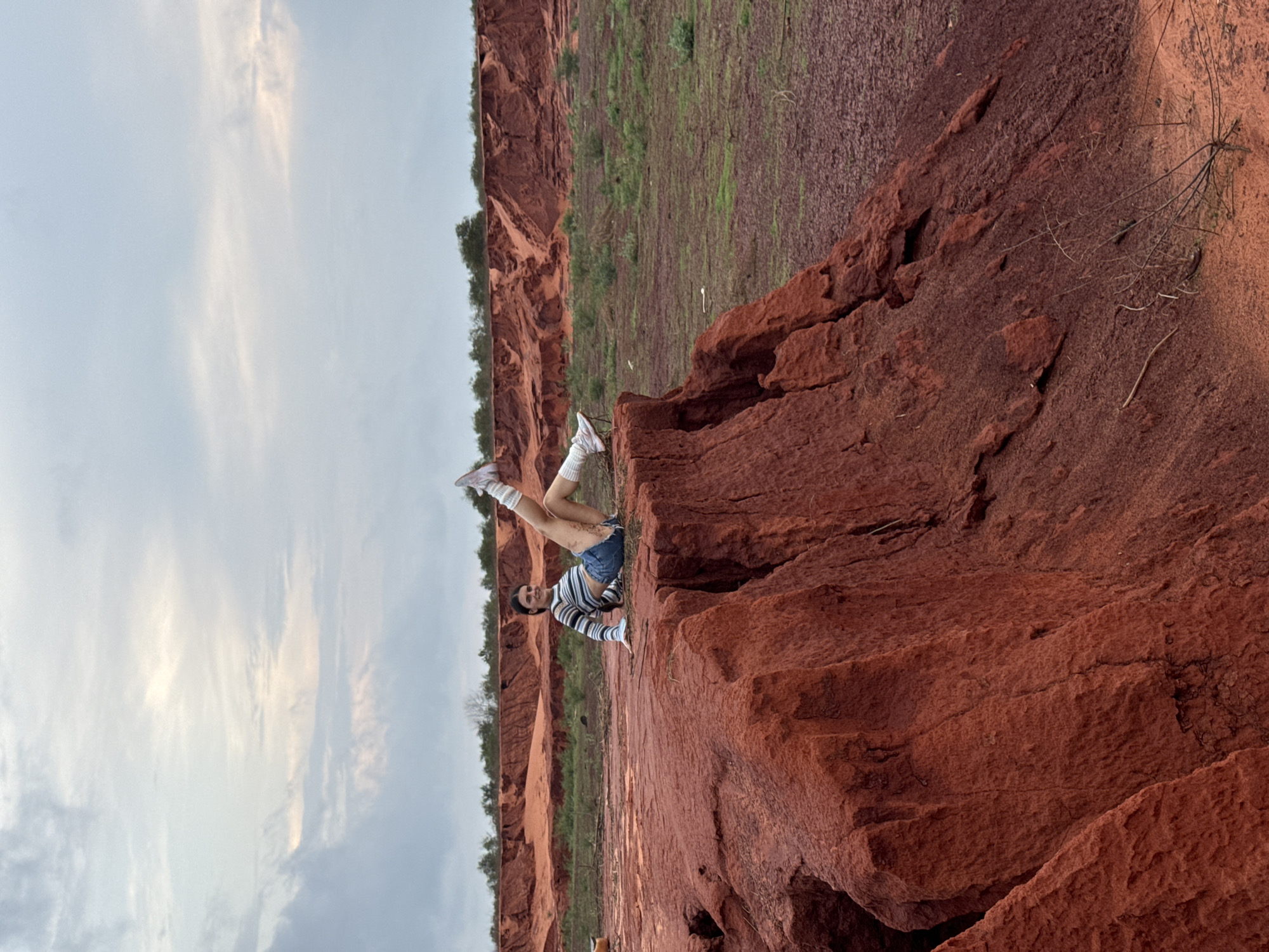Tourist explores dramatic red sand formations in Mui Ne