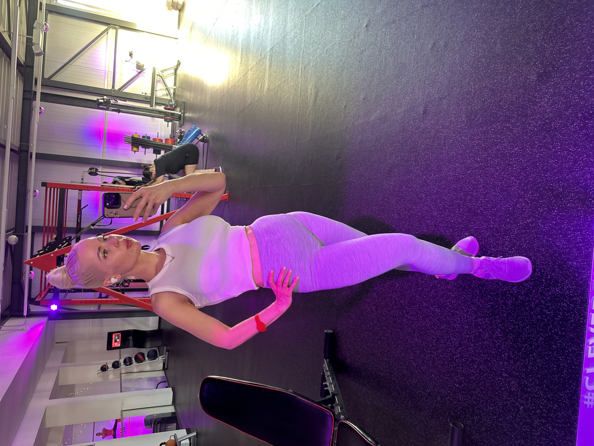 Mirror selfie at a purple-lit gym in Rathenow