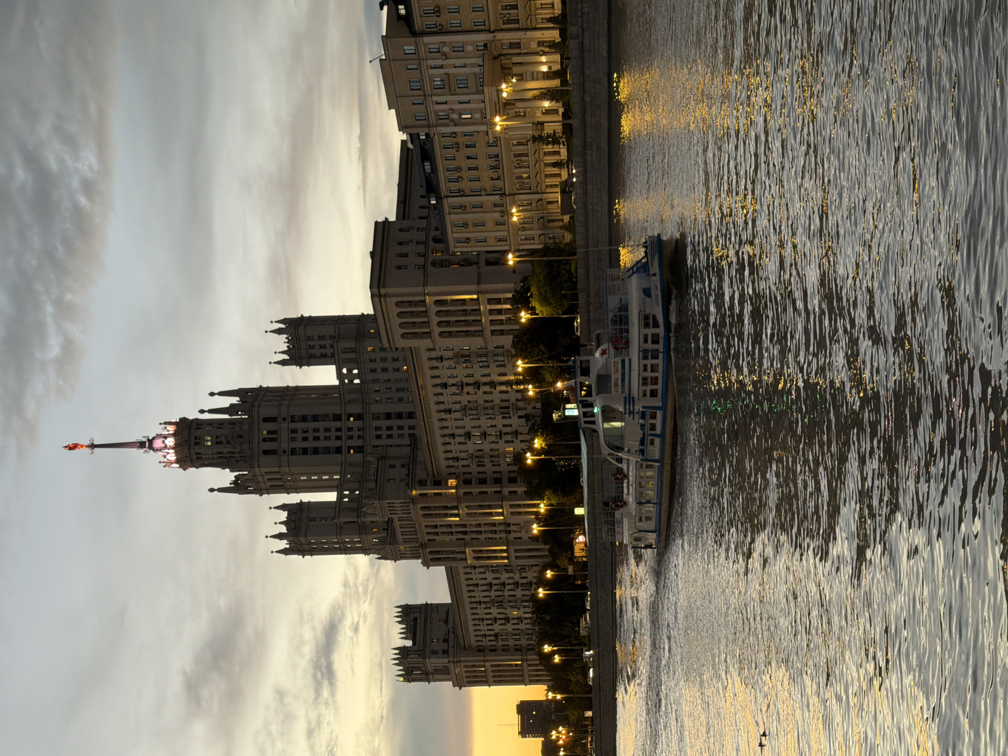 Stalinist skyscraper and Moskva River at dusk