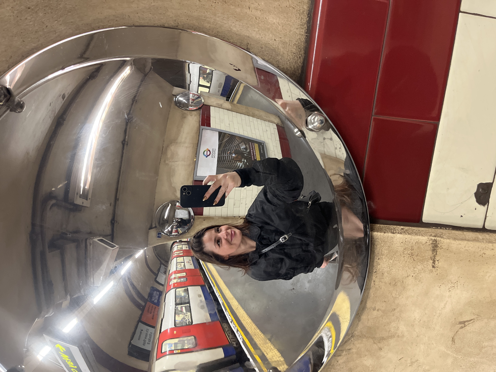 Commuters pose for photos at London Underground station
