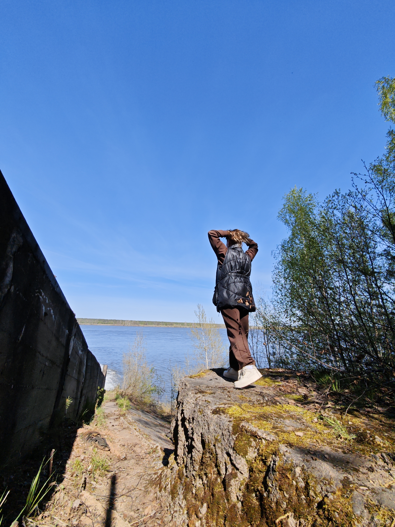 Woman documents dam spillway visit in Chernushka, Russia