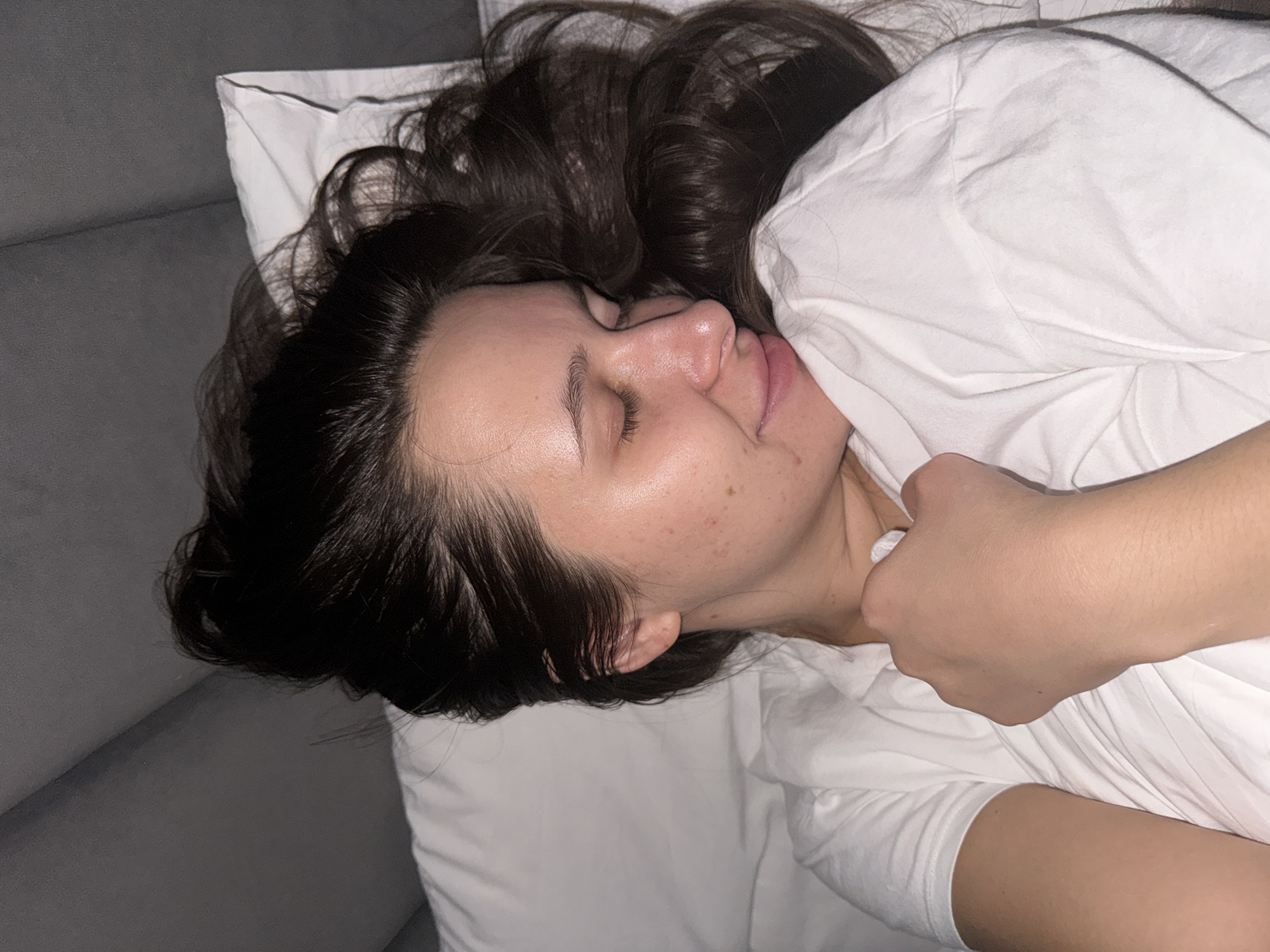 Woman resting on white bedding observed near Akulovo, Russia