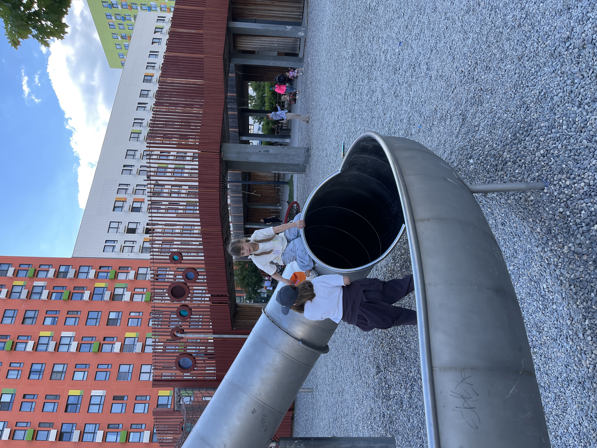 Children play at sunny Kommunarka playground amid residential development