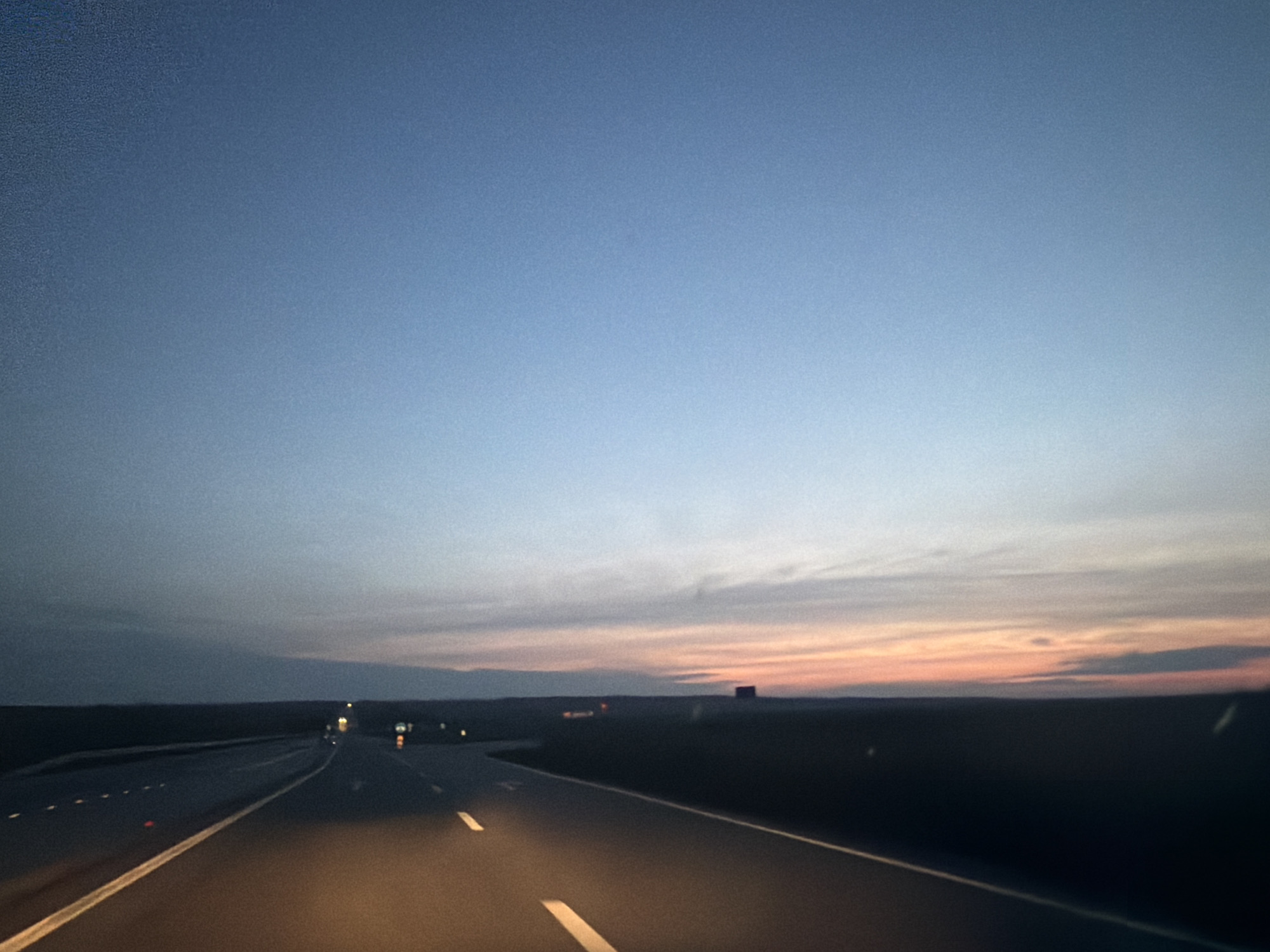 Highway captured at dusk in Romania showing colorful twilight sky