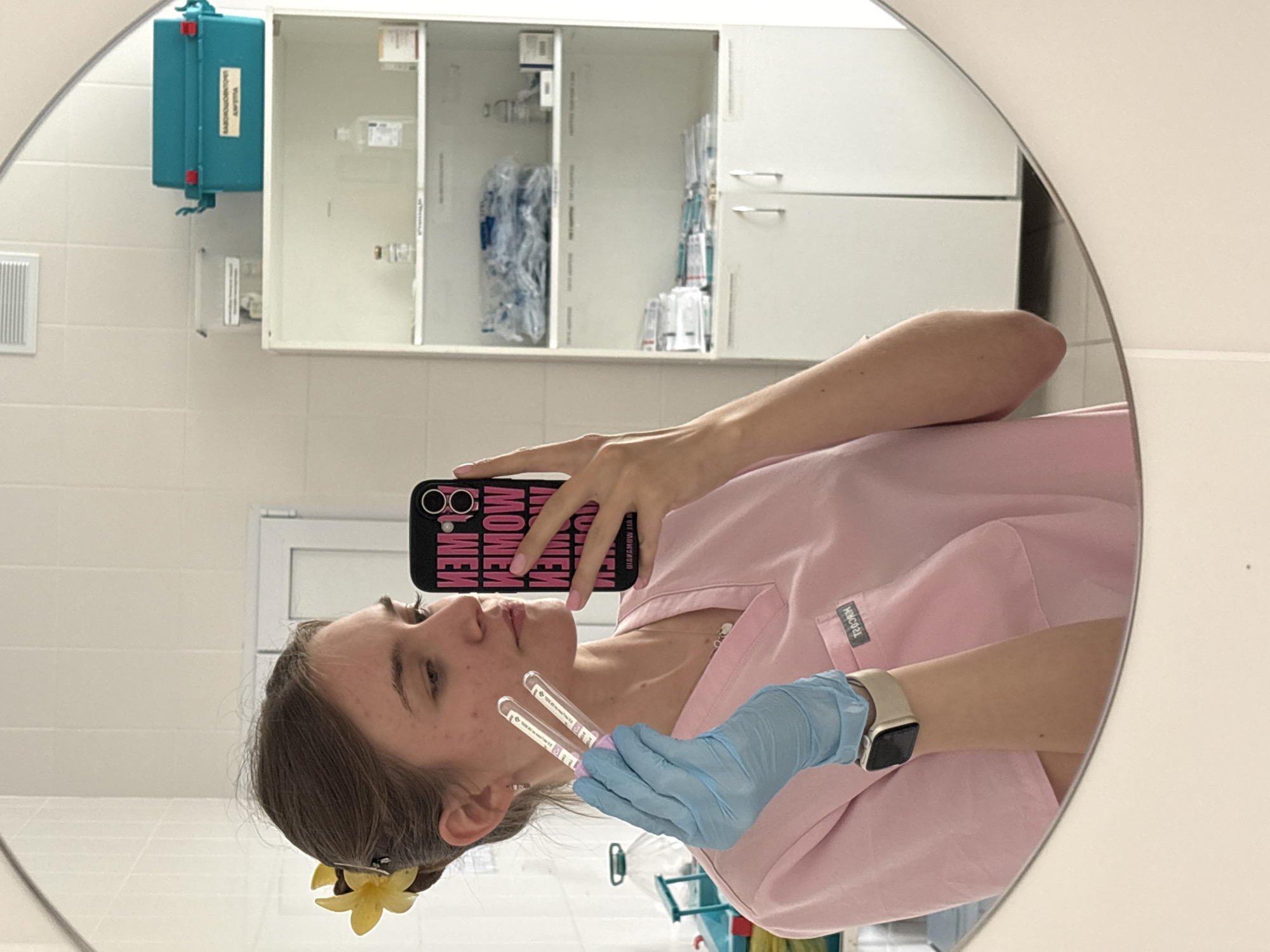 Healthcare worker takes mirror selfie in medical scrubs