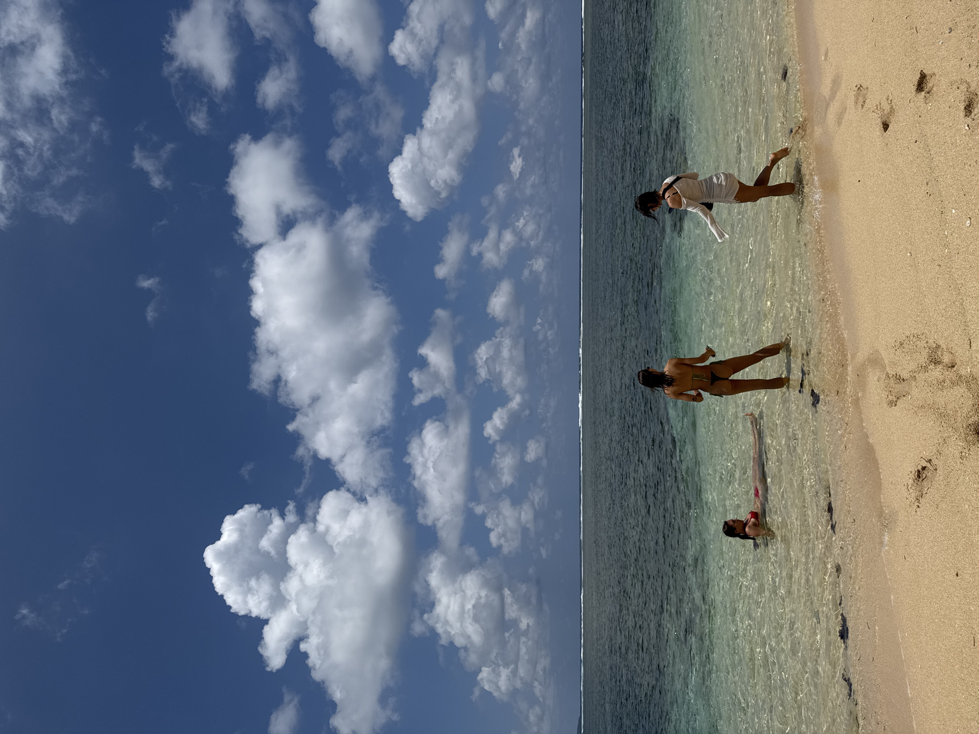 Two women enjoy early morning beach time in General Luna