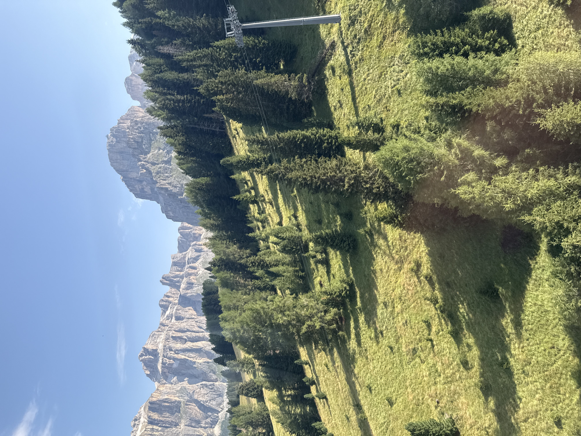 Hiking a sun-lit alpine trail in the Dolomites near Canazei