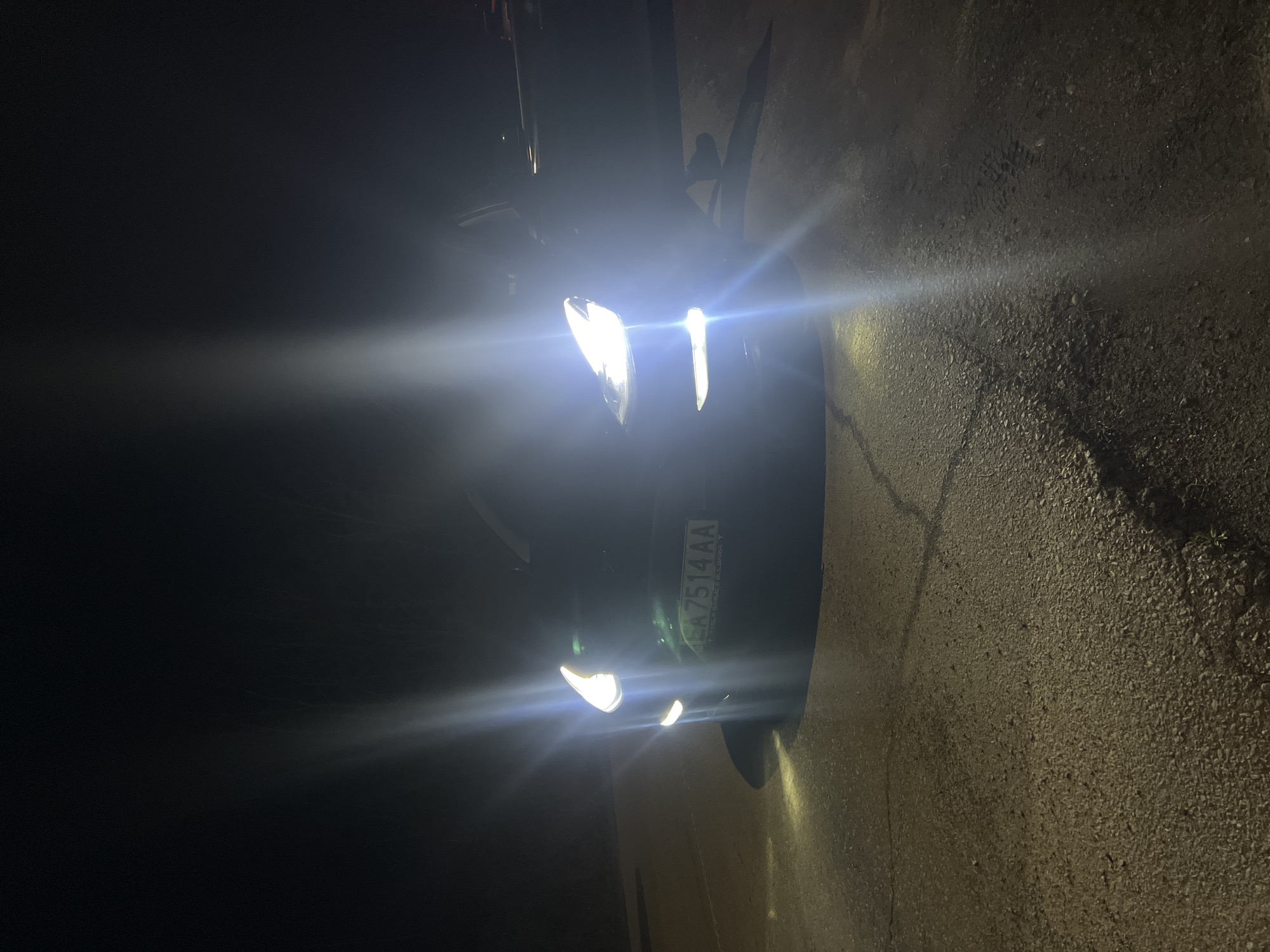 Car with headlights on captured in evening scene