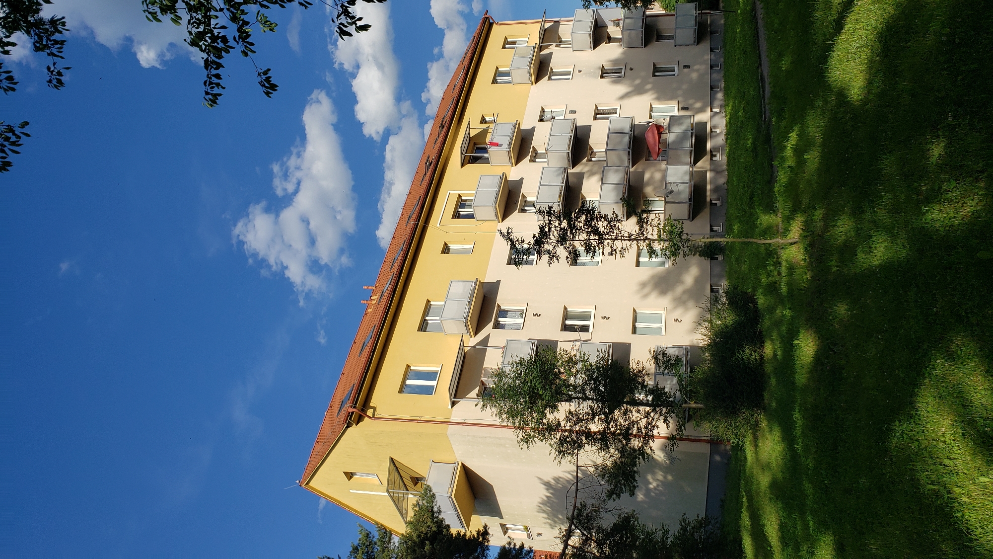 Street-level look at a graffiti-marked residential block in Prešov