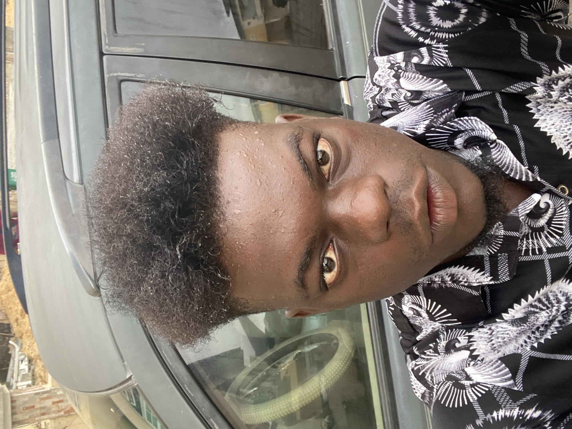Young man photographed with personal belongings in residential area