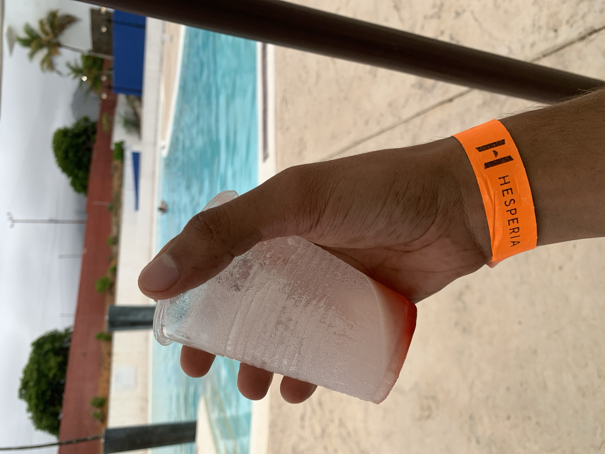 Tourist documents poolside afternoon at Venezuelan beach resort