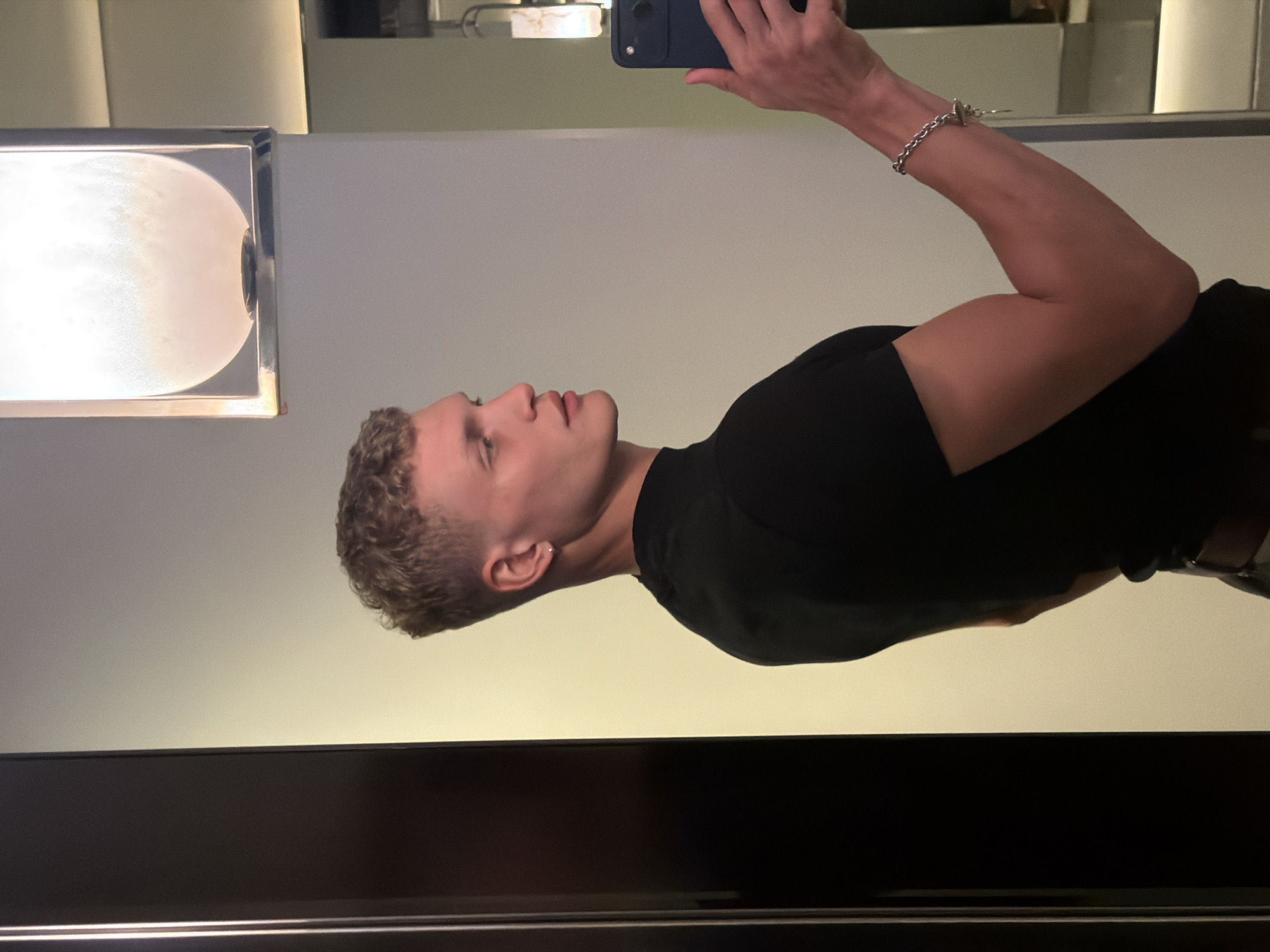 Mirror selfie in London, black tee and silver bracelet.