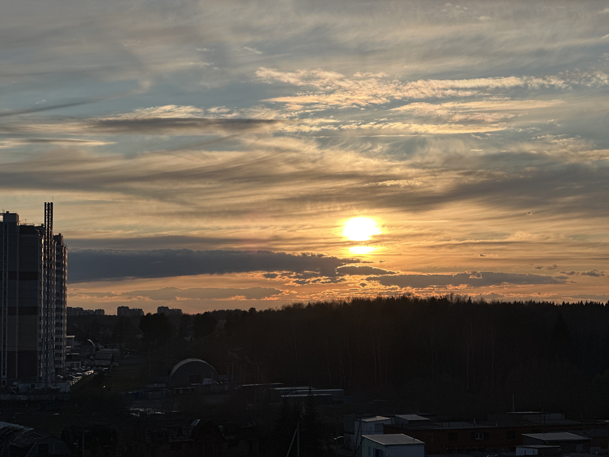 Sunset observed over Zelenograd with illuminated clouds