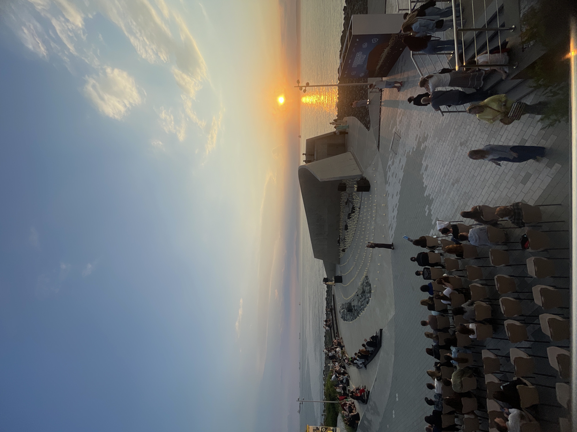 Candlelit outdoor concert at Vladivostok's waterfront embankment at dusk