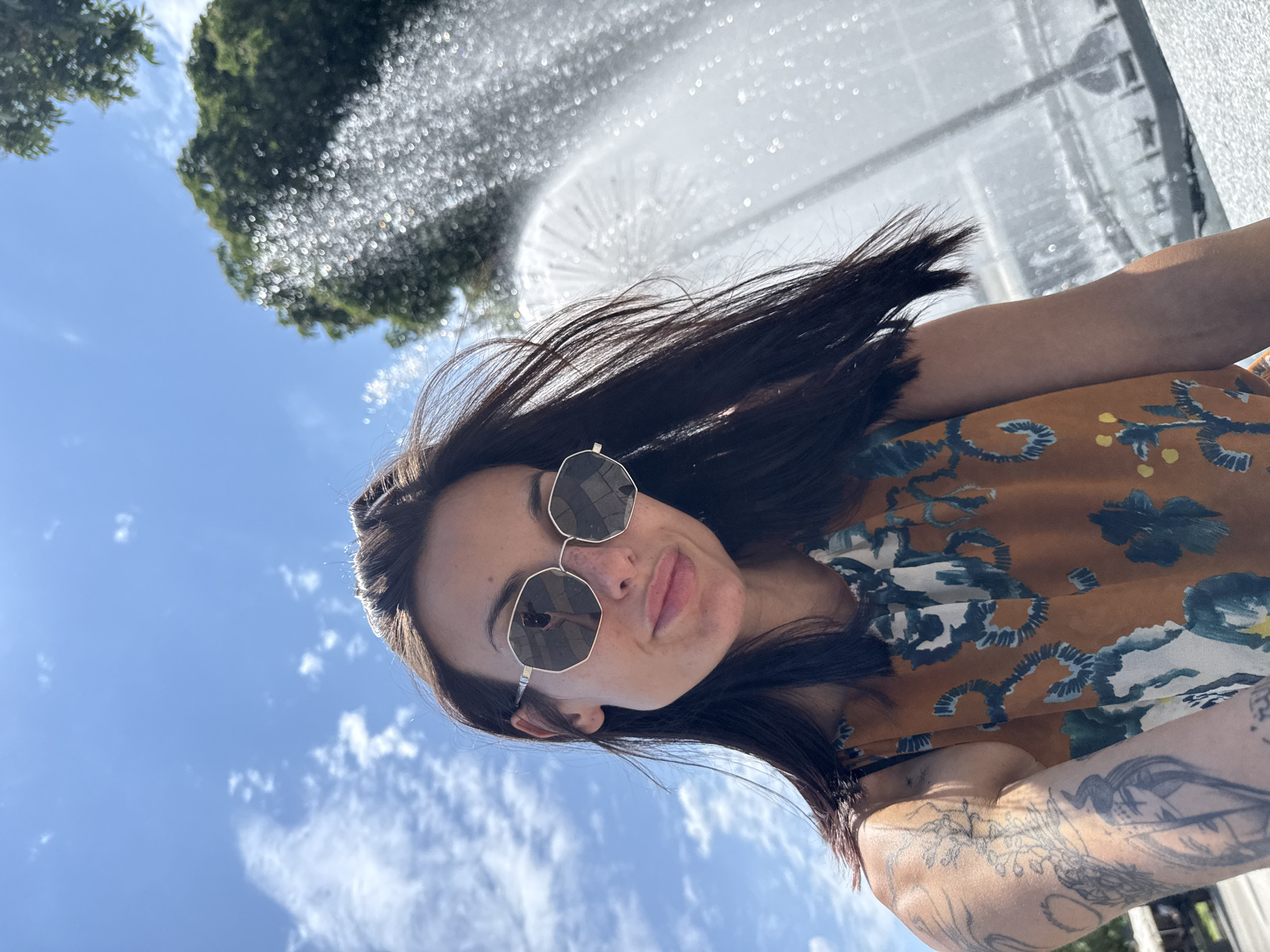 Woman takes selfie at active fountain in Pleven park