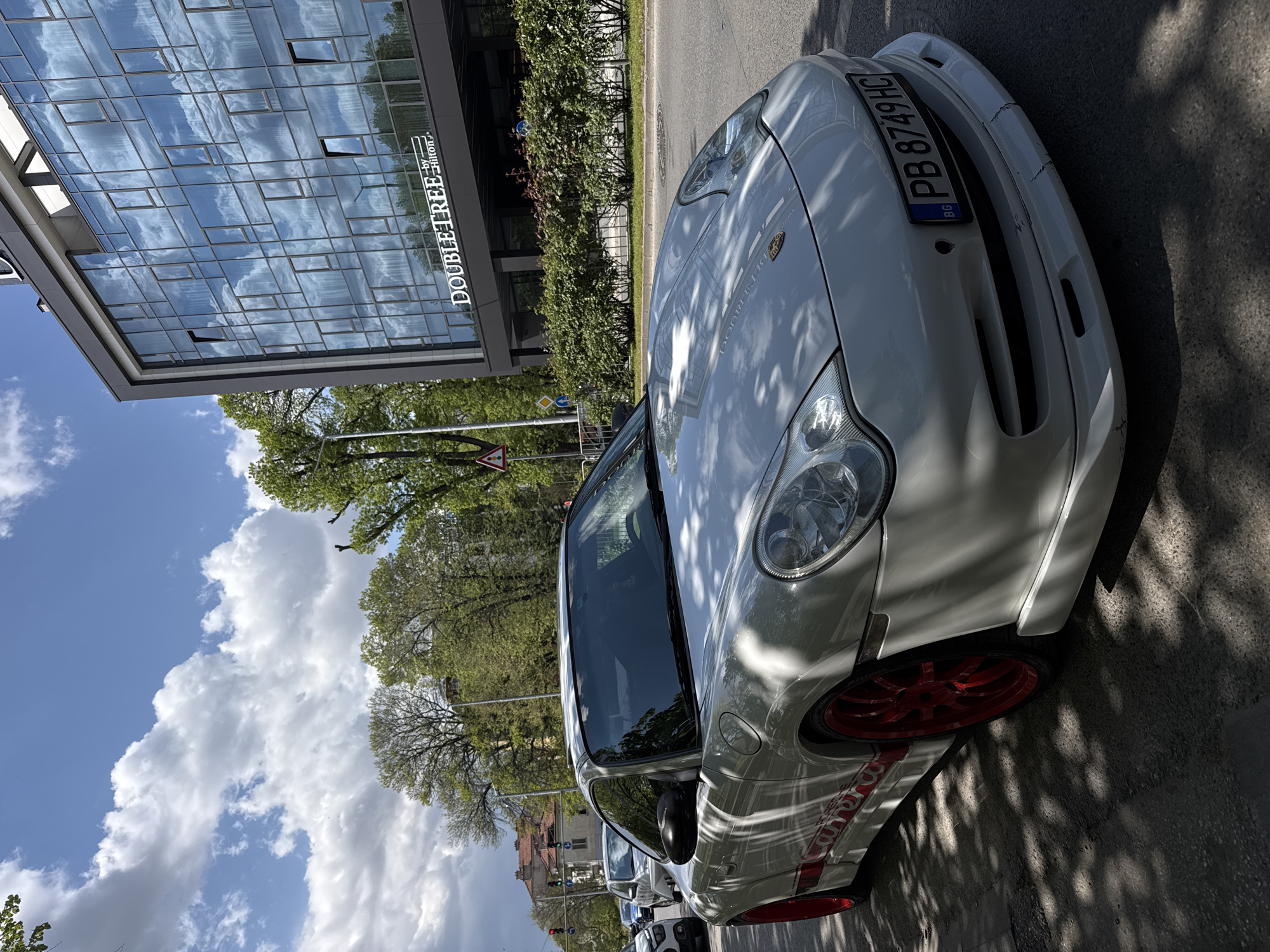 Man poses with white Porsche for selfies in Plovdiv