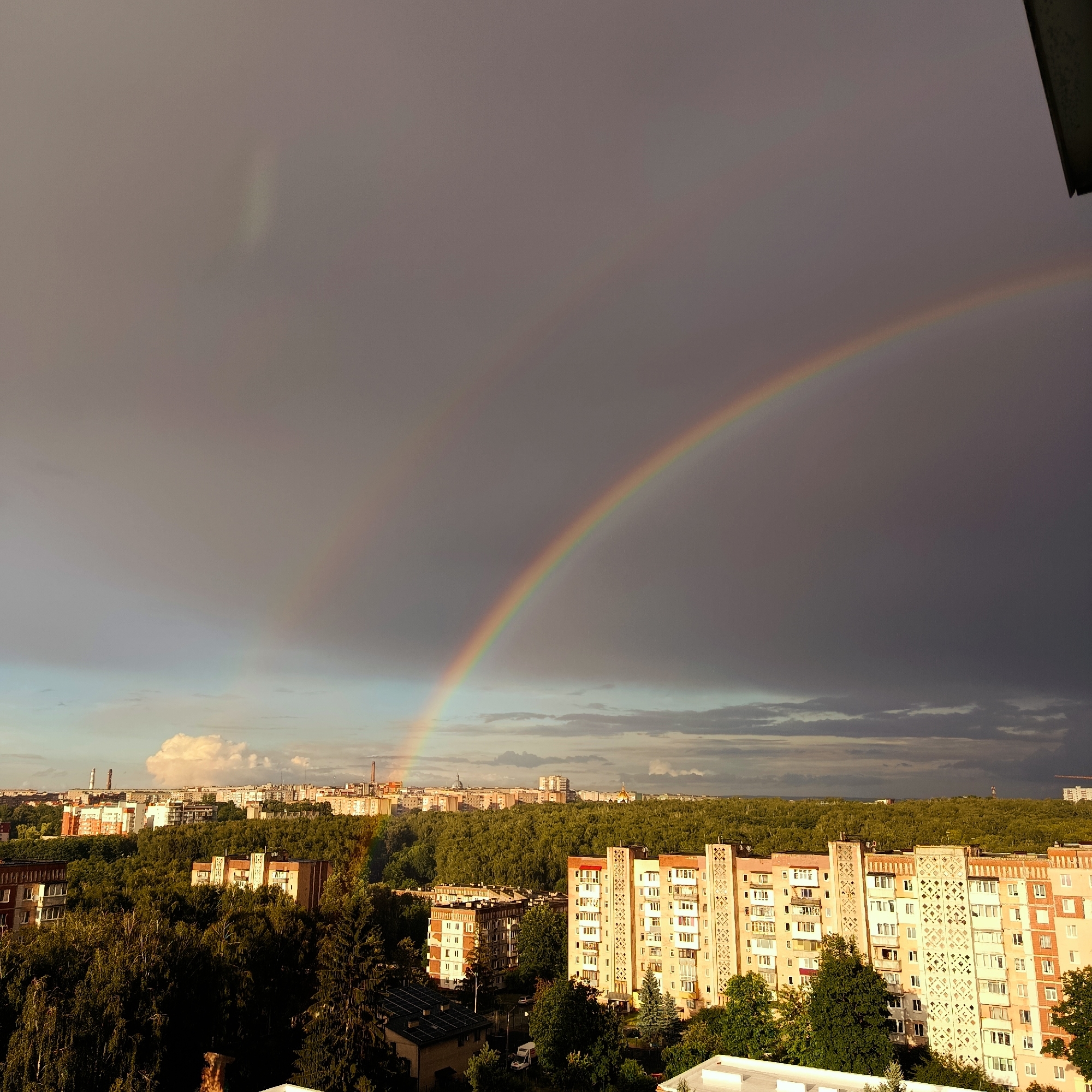 Rainbow over the city skyline after a storm