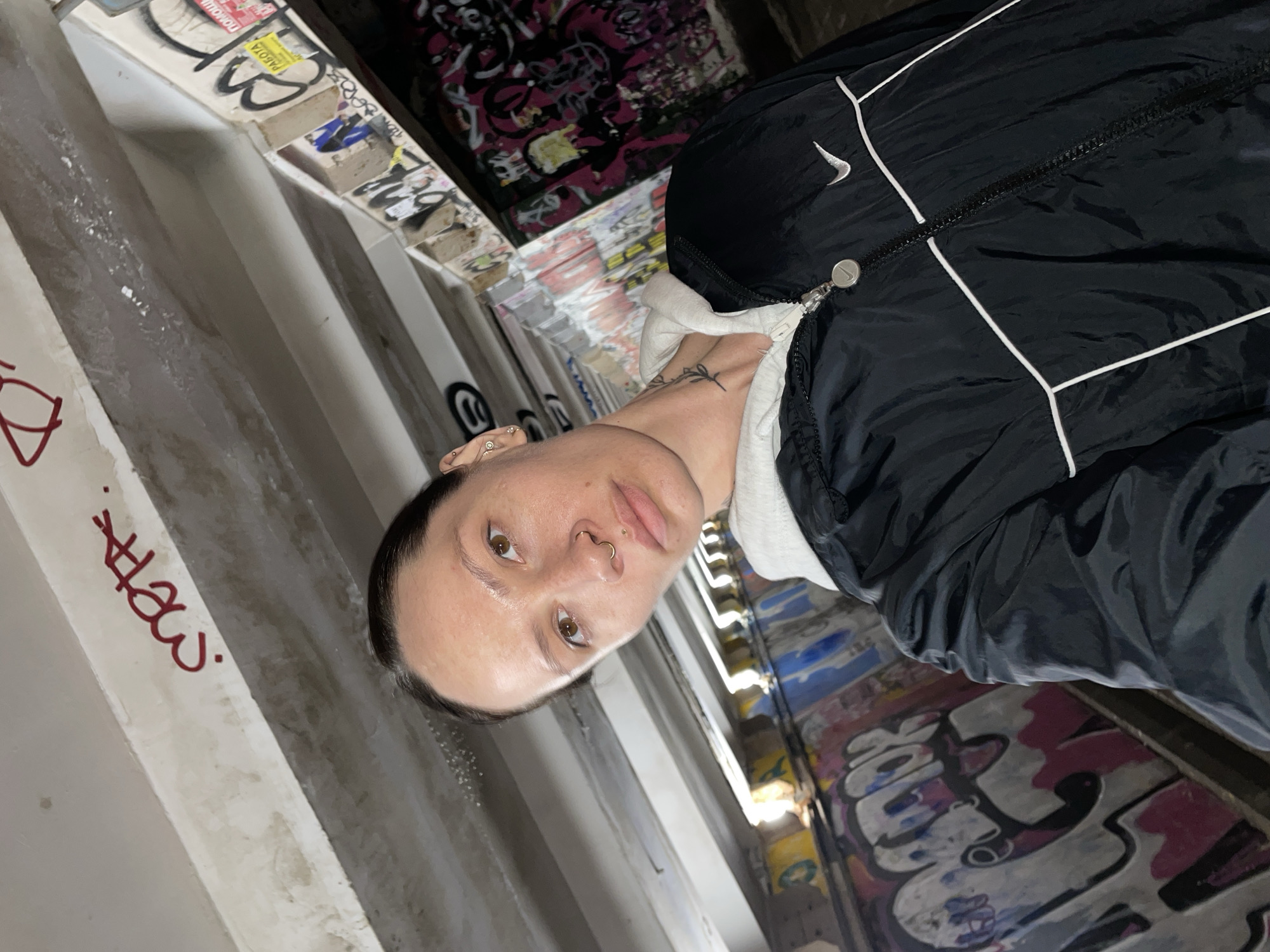 Person poses against graffiti wall in Izhevsk