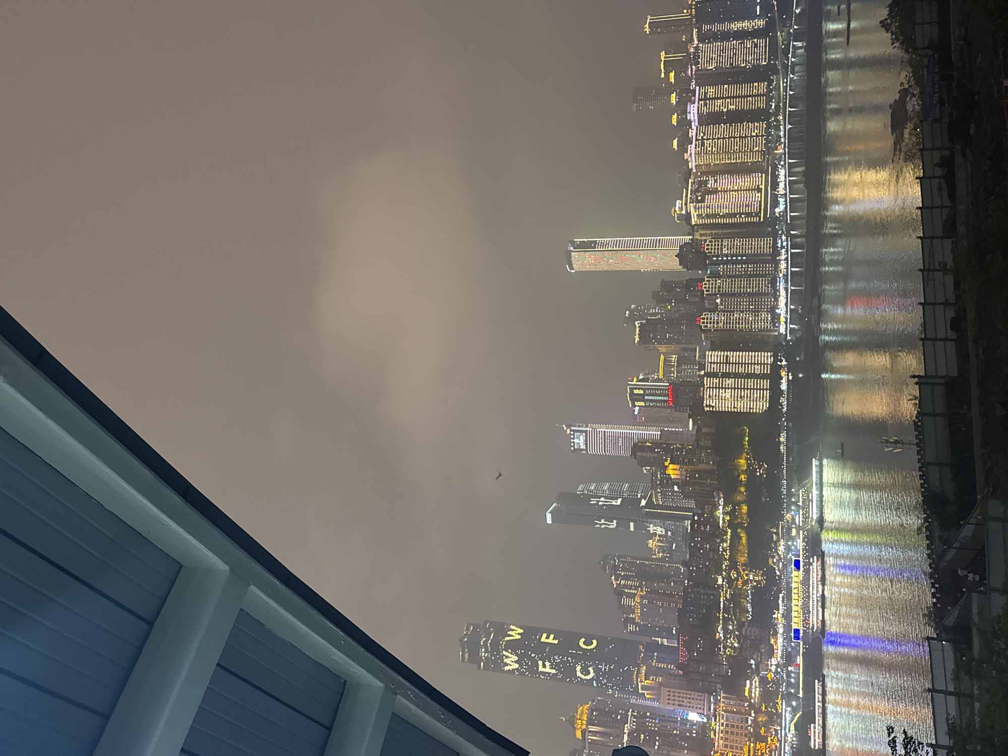 Chongqing's illuminated skyline and red bridge captured at night