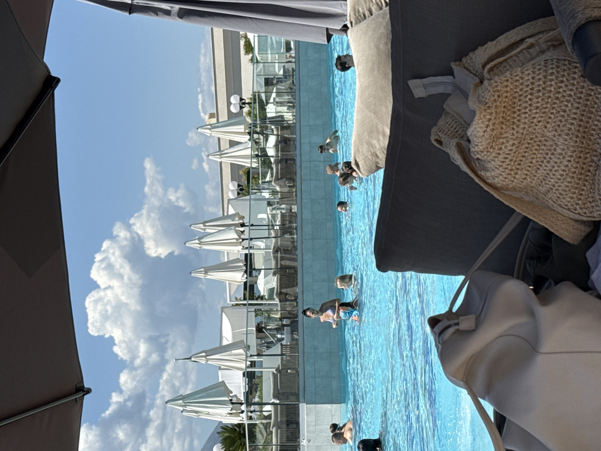 Resort guest enjoys poolside morning with breakfast and sunbathing