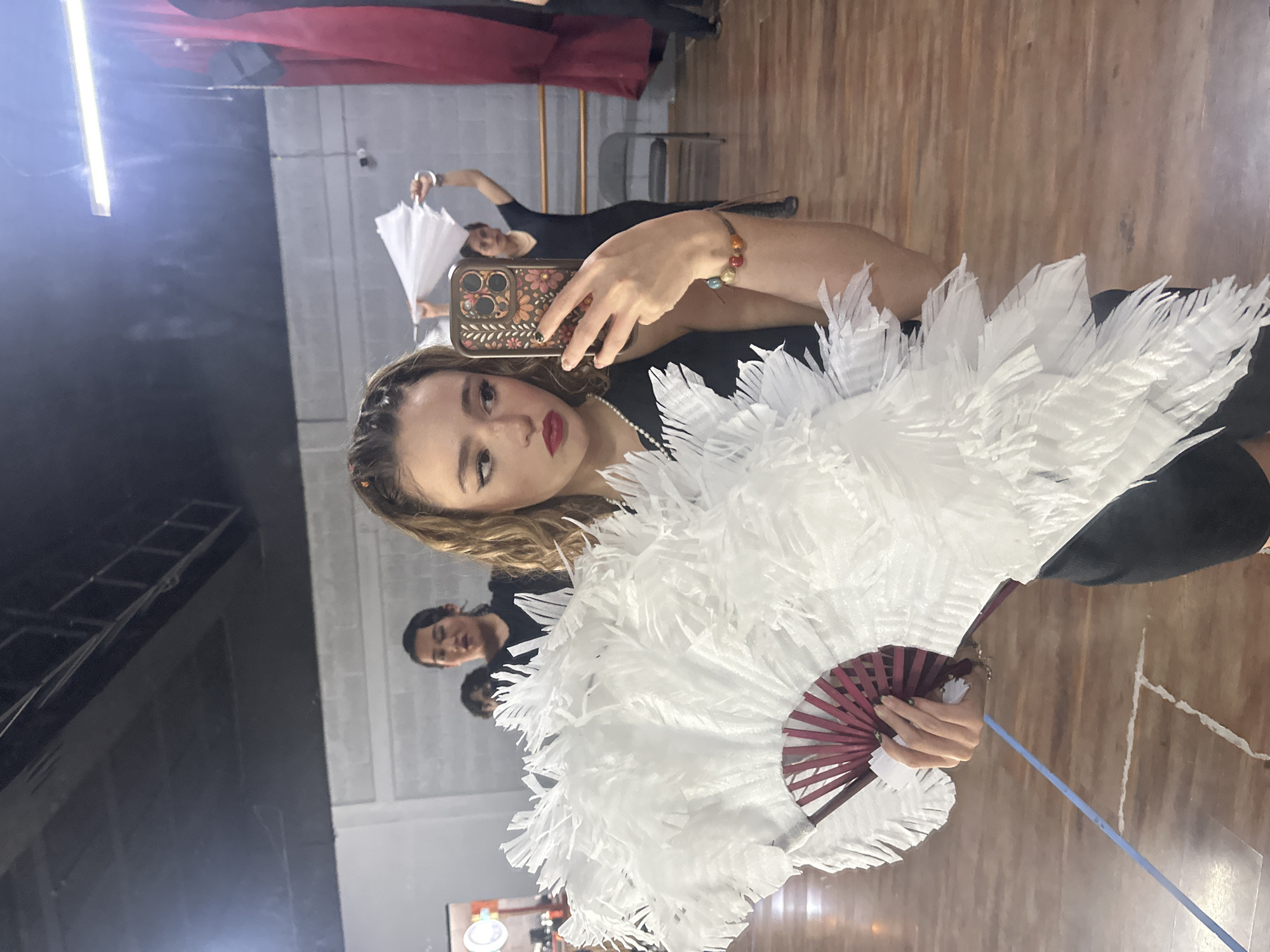 Dance rehearsal with white feather fans in a Puebla studio