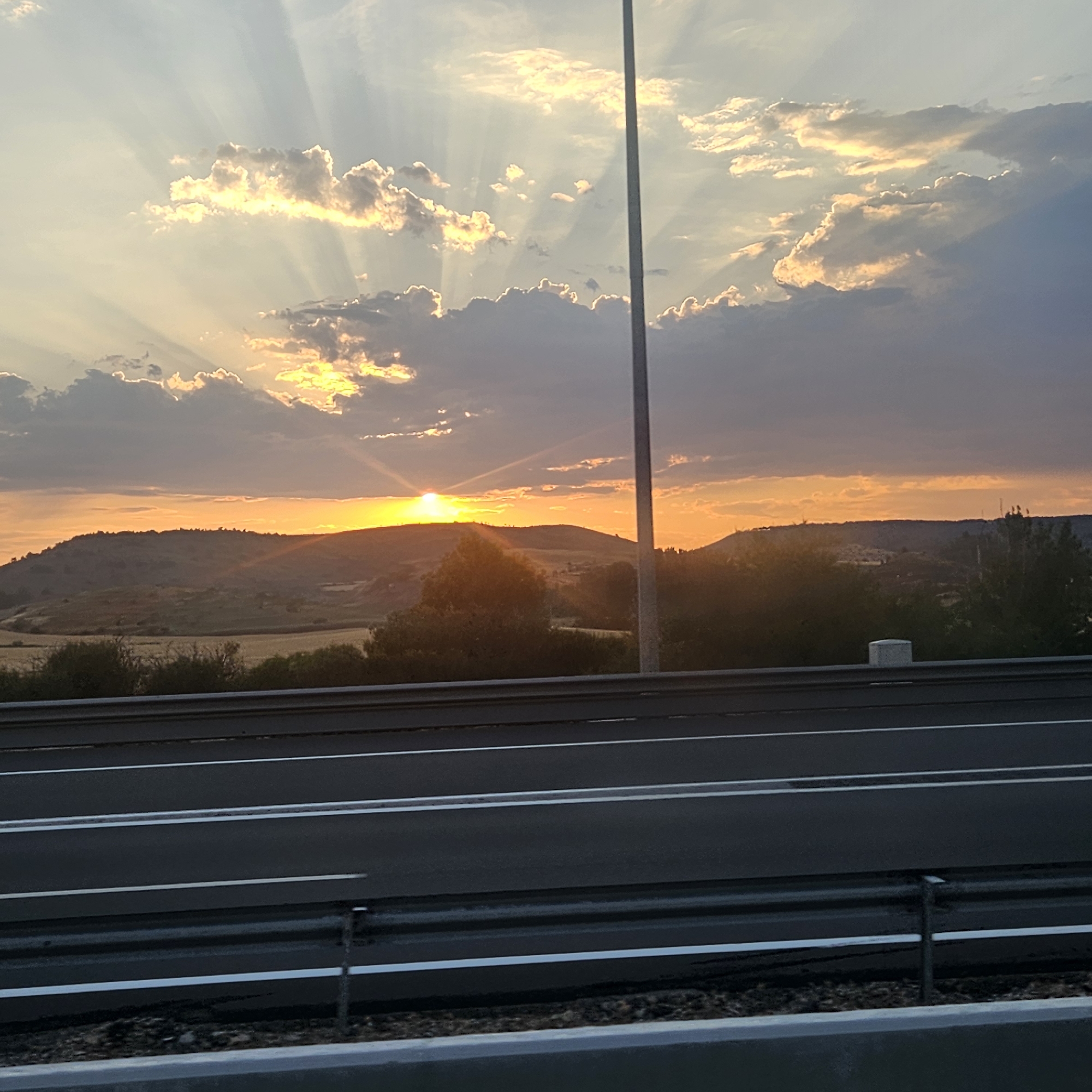 Orange sunset drops over the rolling hills of Medinaceli